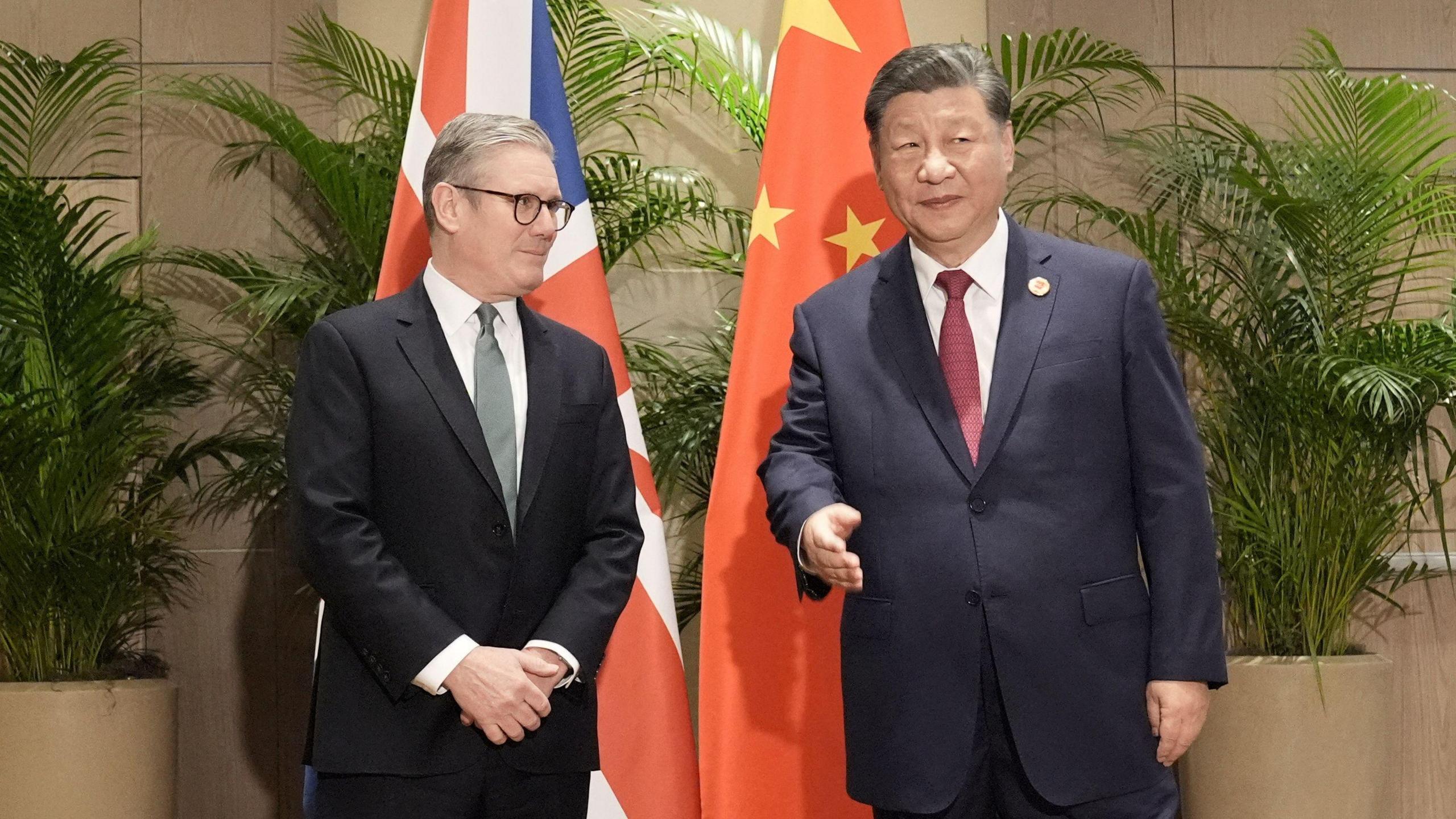 British Prime Minister Keir Starmer has met President Xi Jinping in Rio at the G20 summit. They stand in front of British and Chinese flags. 