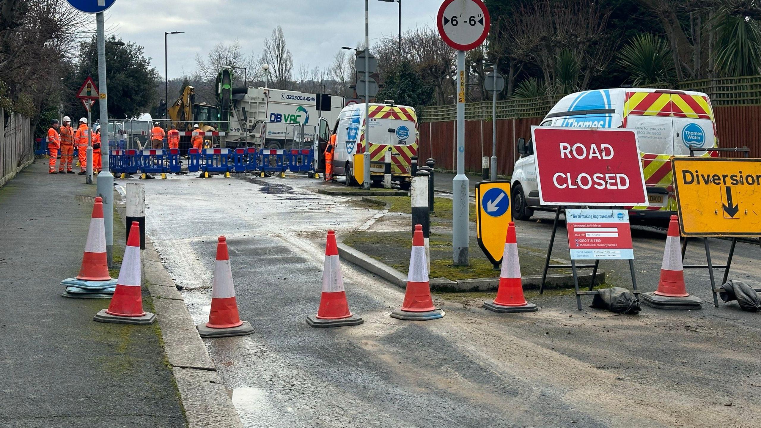 A road closed off with cones as Thames Water carries out repair work in the distance 