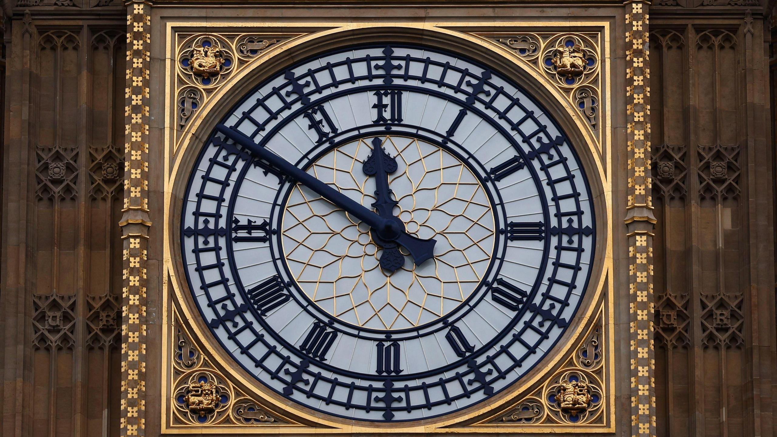 The black and gold clock face of Big Ben in London.