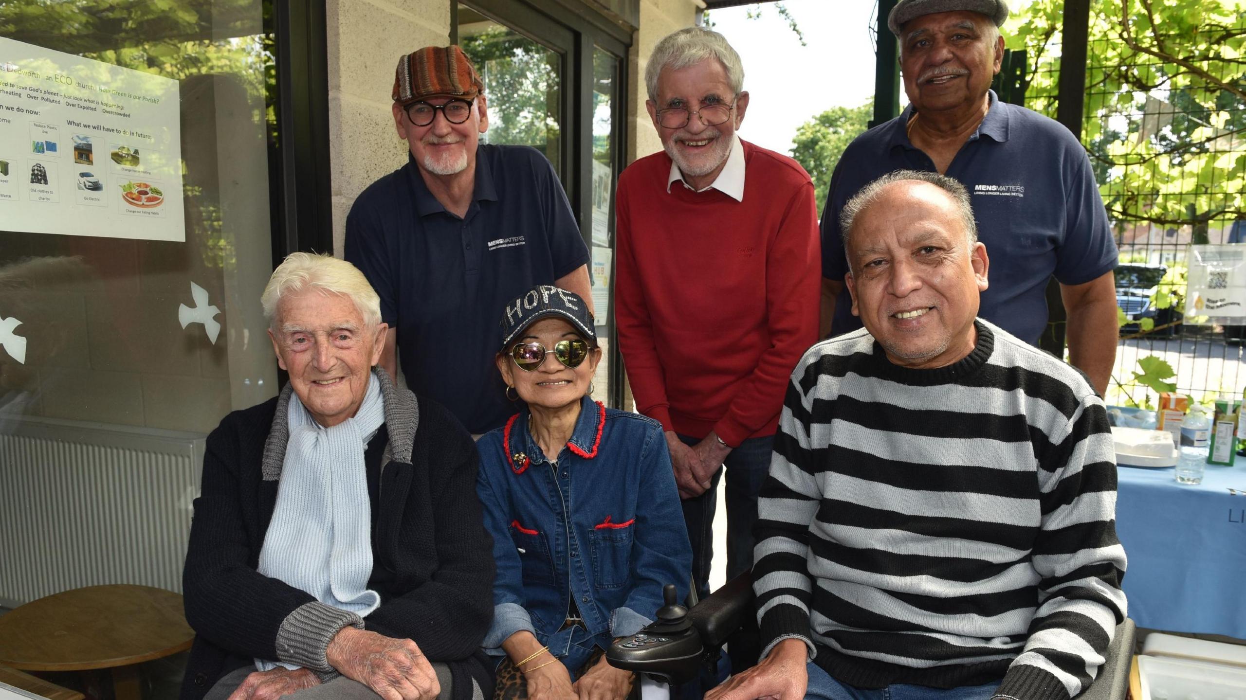 Sir Michael Parkinson with five other gentlemen at a summer barbeque.