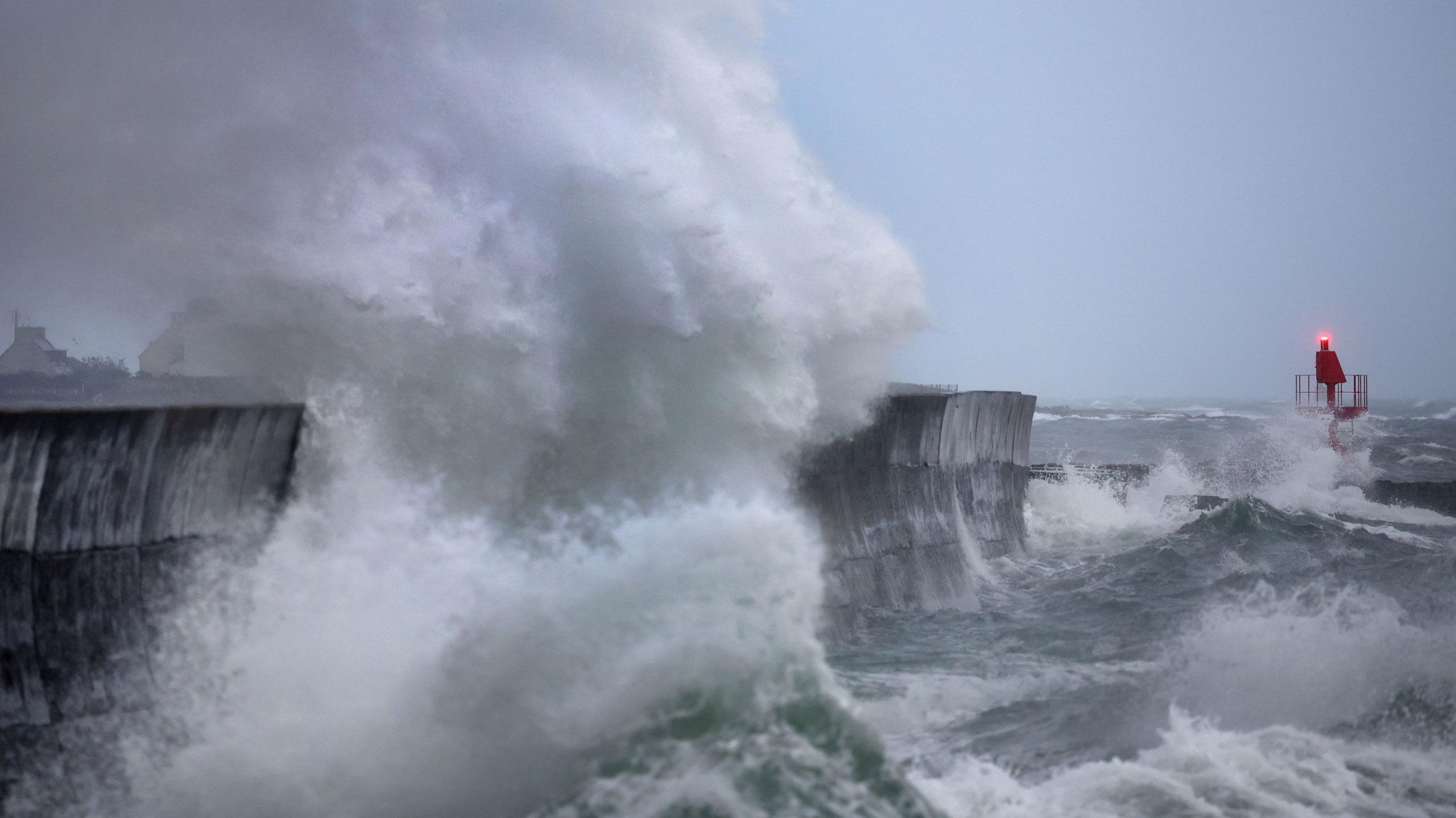 Large waves in western France spraying whitewash up high as it collides with a port