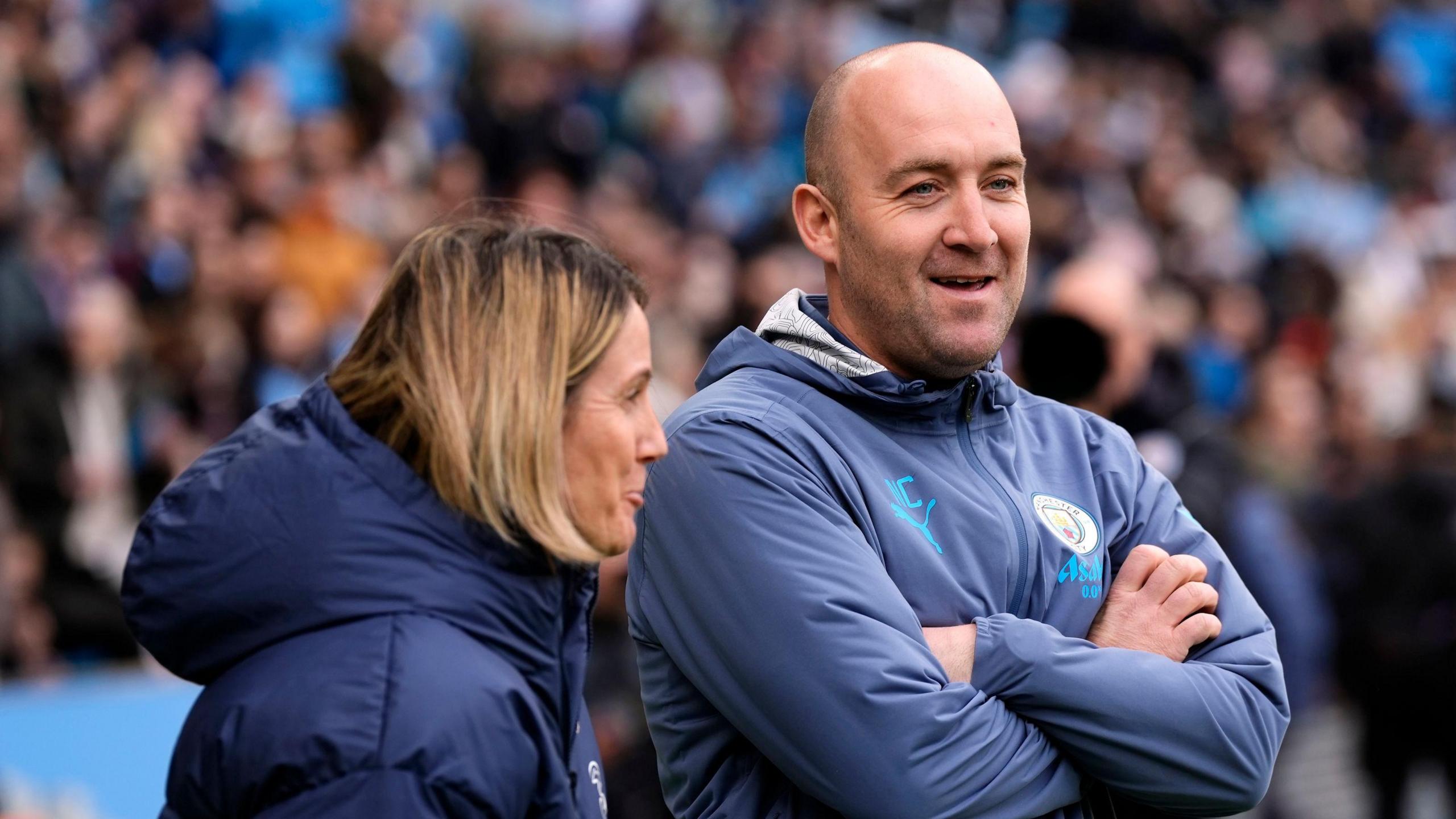 Sonia Bompastor chats to Nick Cushing on the touchline