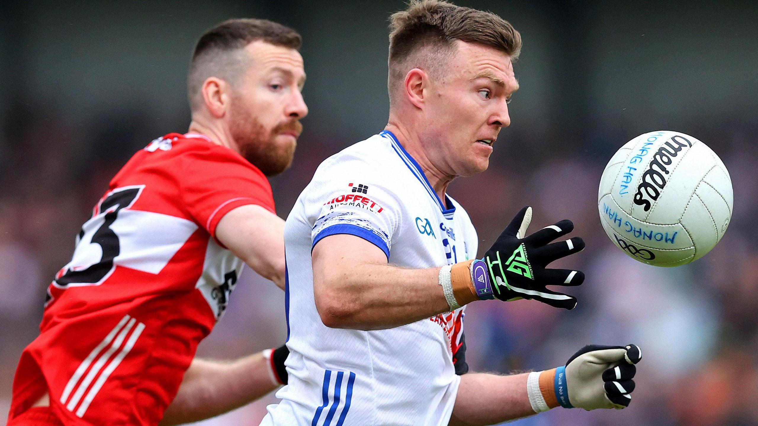 Conor McCarthy is challenged by Niall Loughlan 