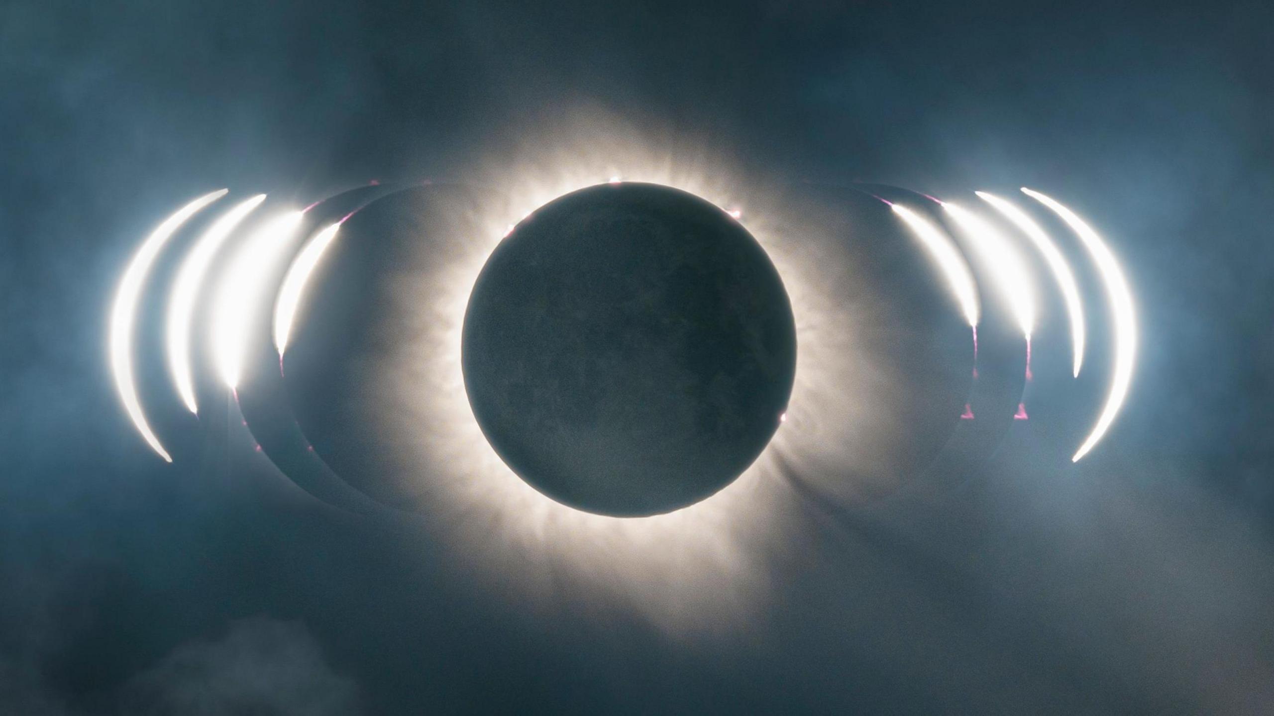 A picture of a solar eclipse. There is a large black sky with light in the middle from the moon.
