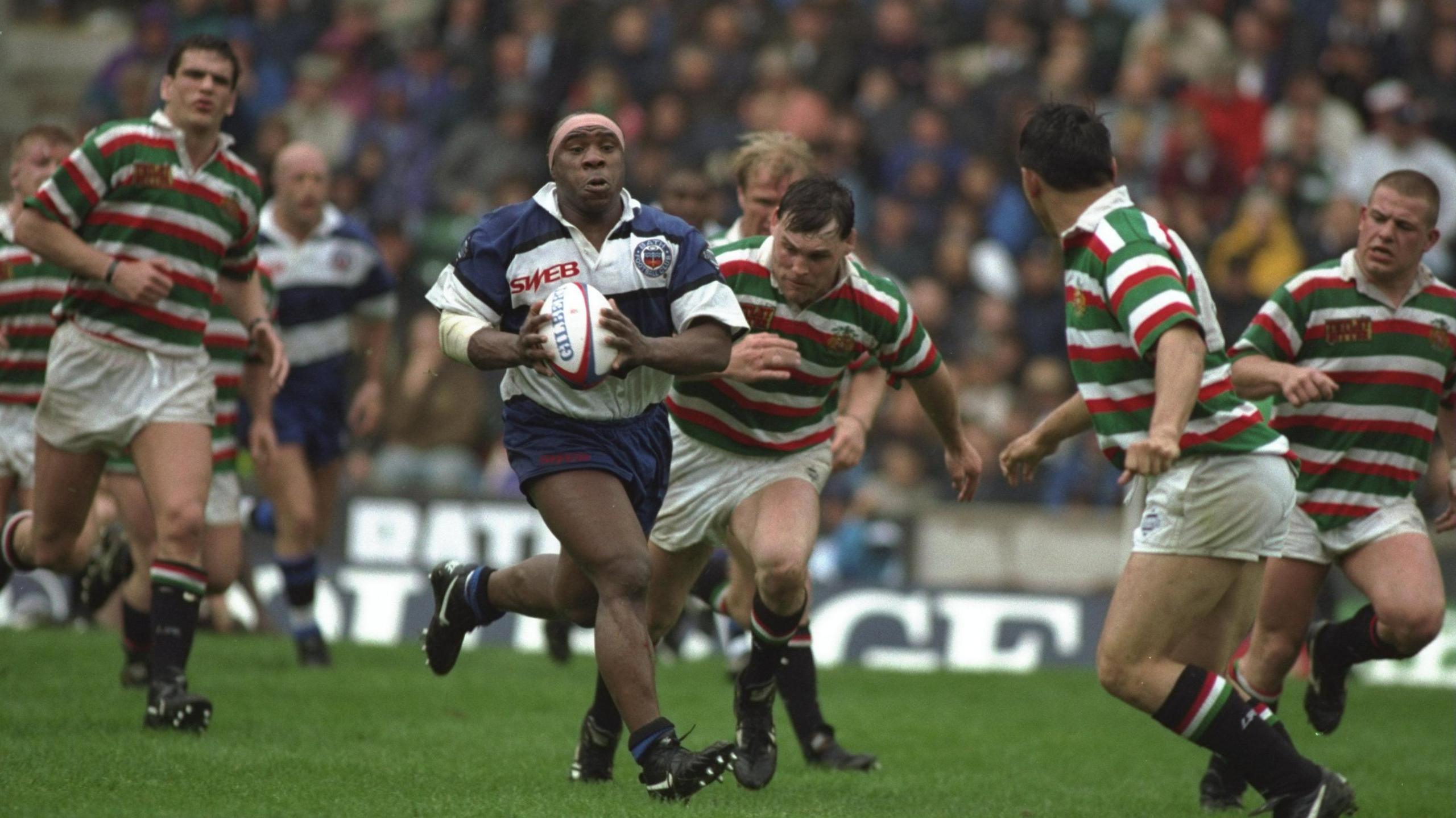 Victor Ubogu runs with the ball clear of a Leicester tackler during the 1994 Pilkington Cup final