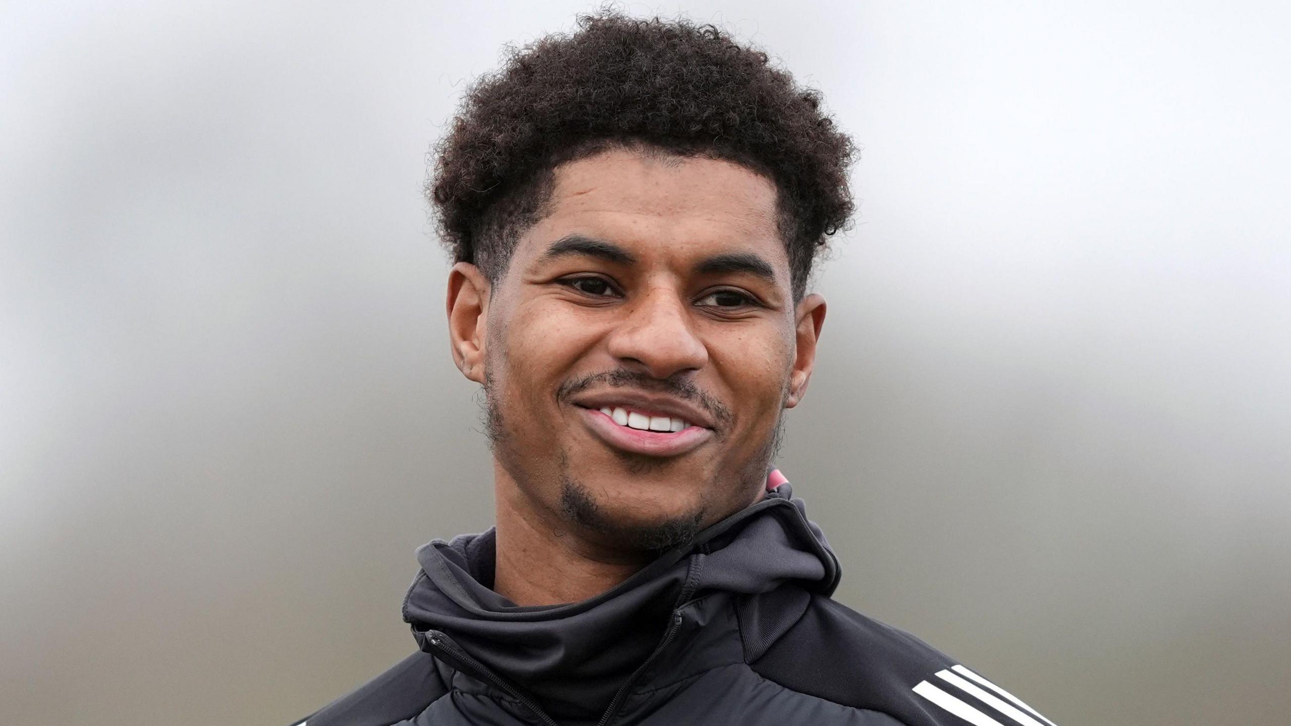 Marcus Rashford, smiling, during a training session for Manchester United at the Trafford Training Centre, Carrington. 