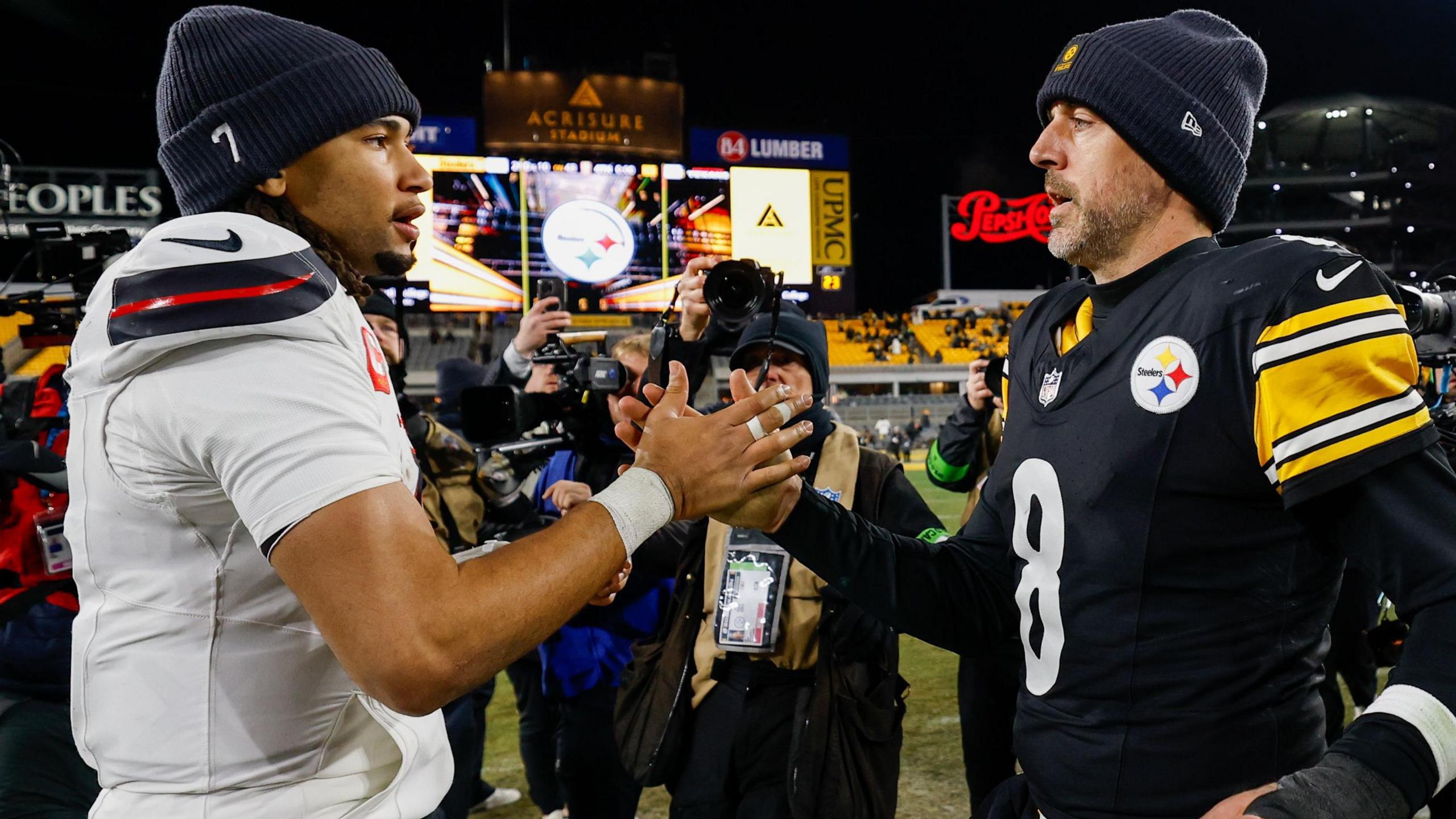 Pittsburgh Steelers quarterback Aaron Rodgers shakes hands with Houston Texans quarterback CJ Stroud after their NFL play-off game