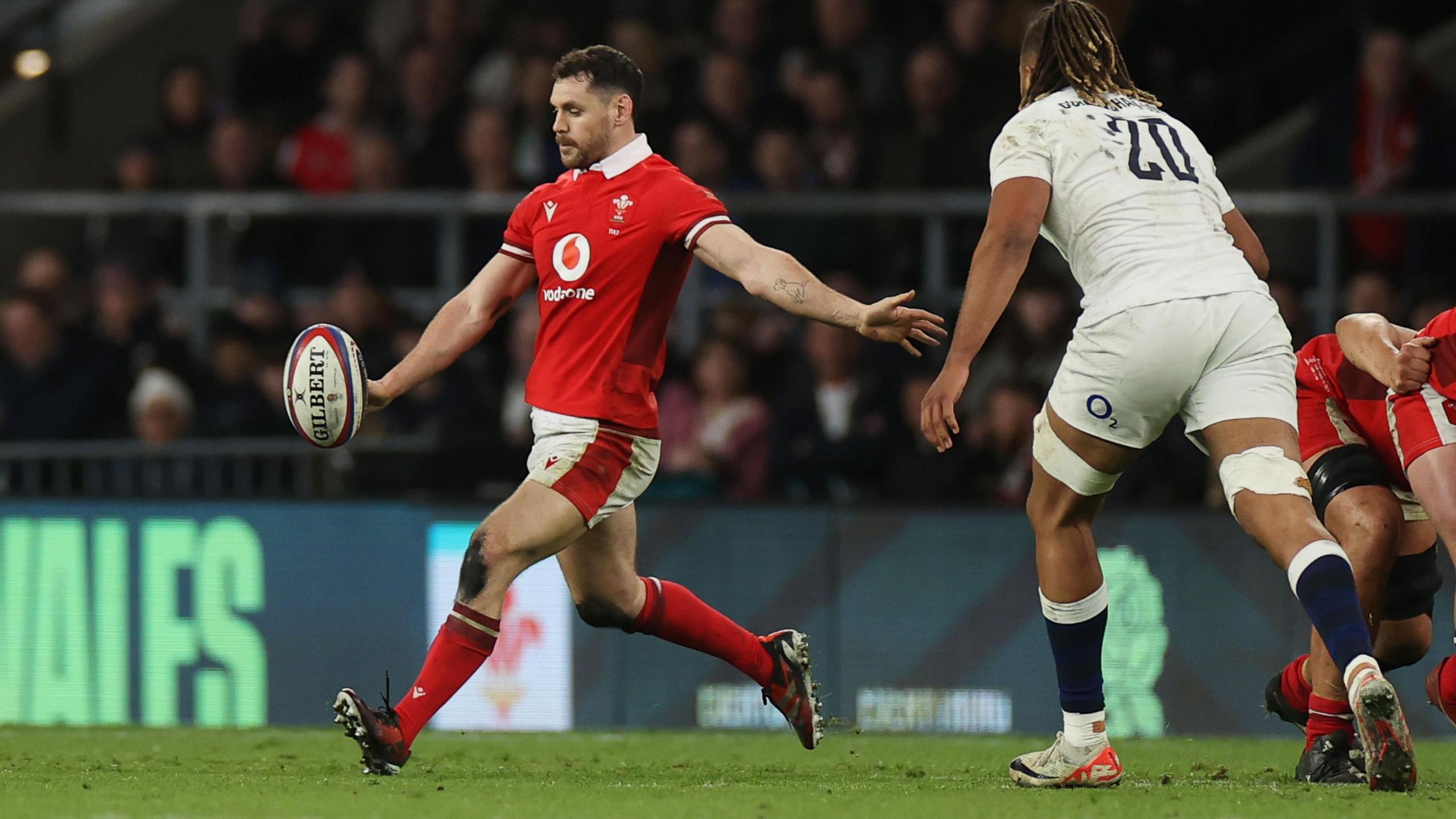 Tomos Williams kicks the ball for Wales against England