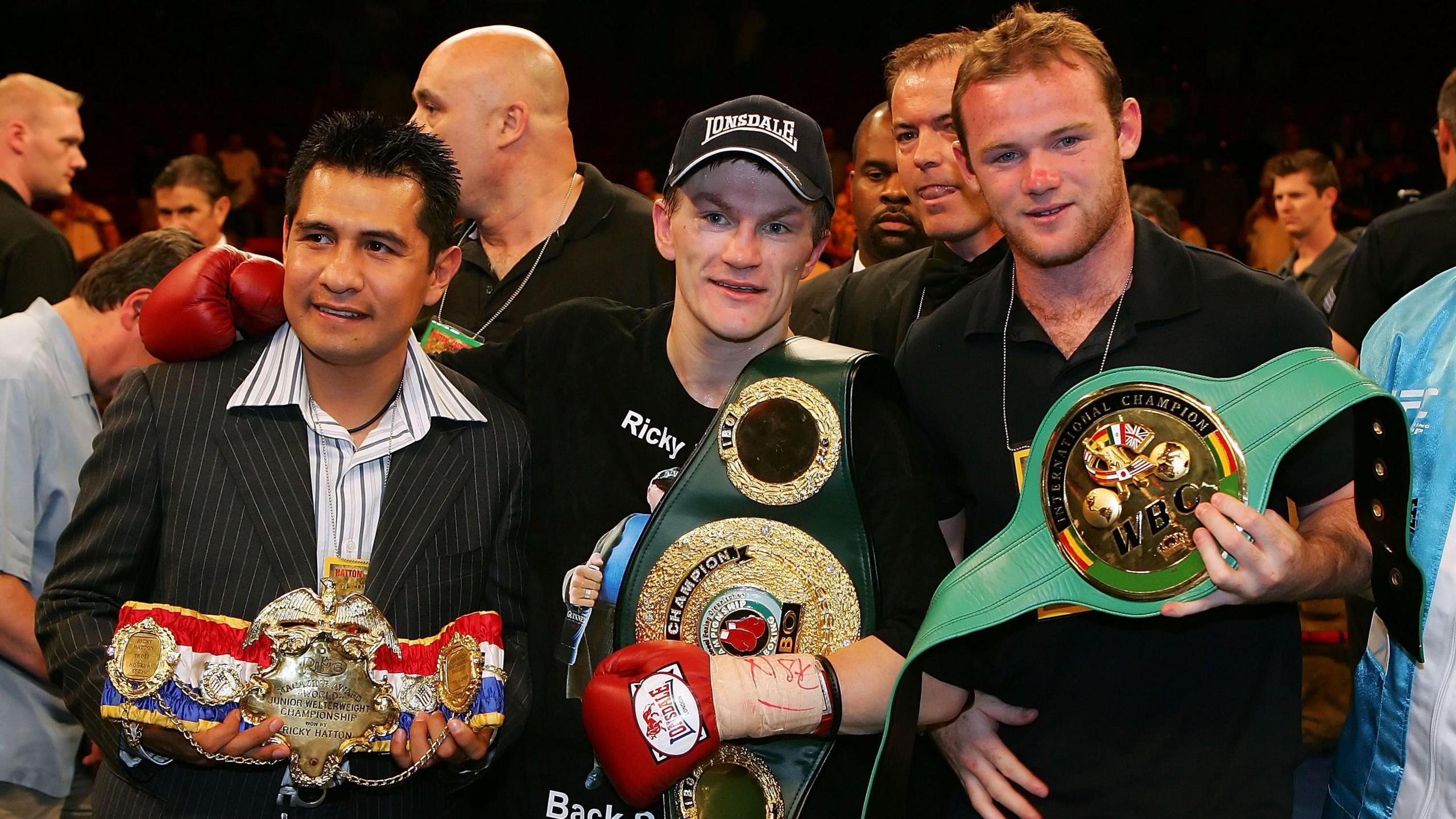 Marco Antonio Barrera, Ricky Hatton and Wayne Rooney pose with the belts