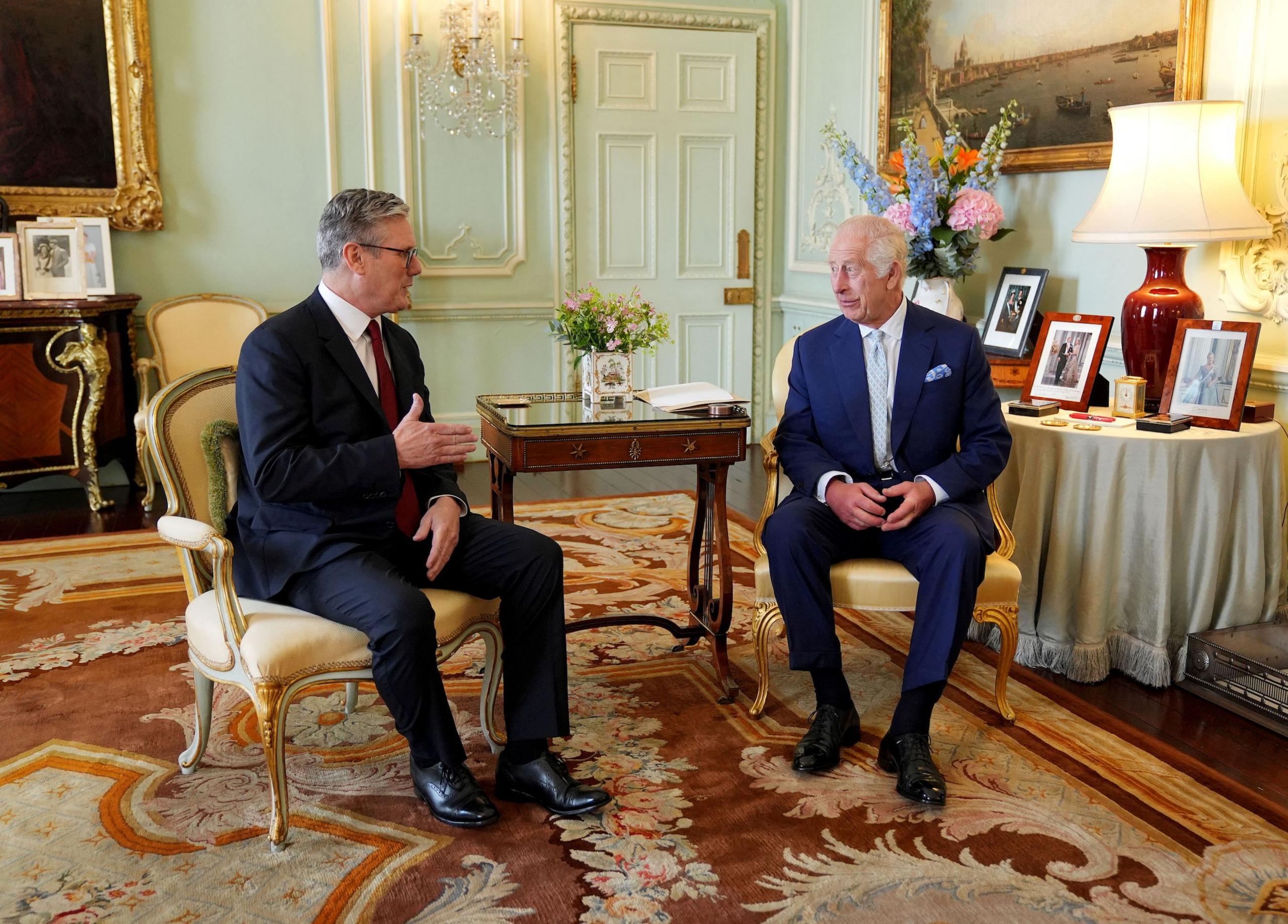 Sir Keir Starmer and King Charles sit and talk in Buckingham Palace