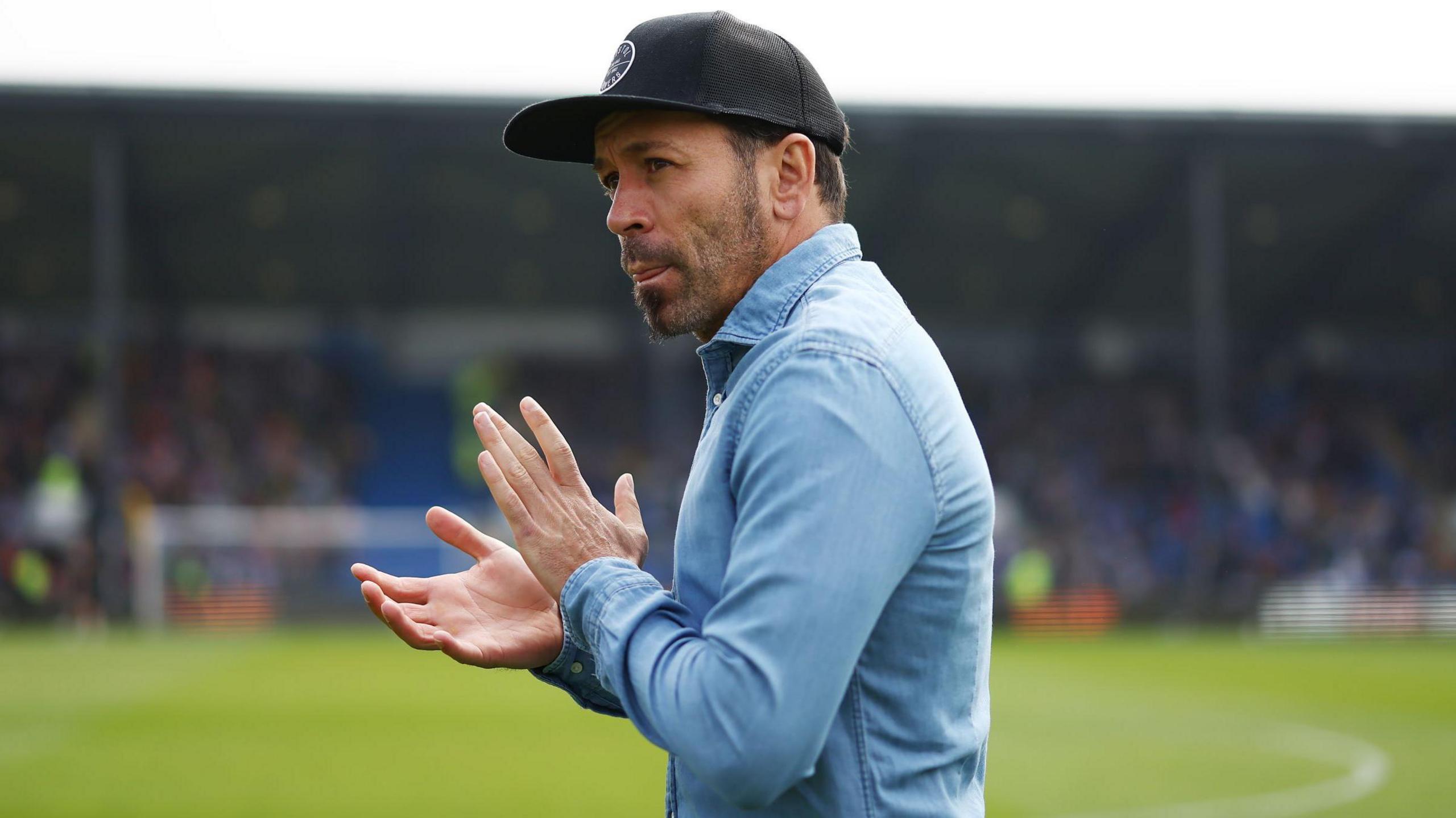 Inigo Calderon claps fans on the pitch