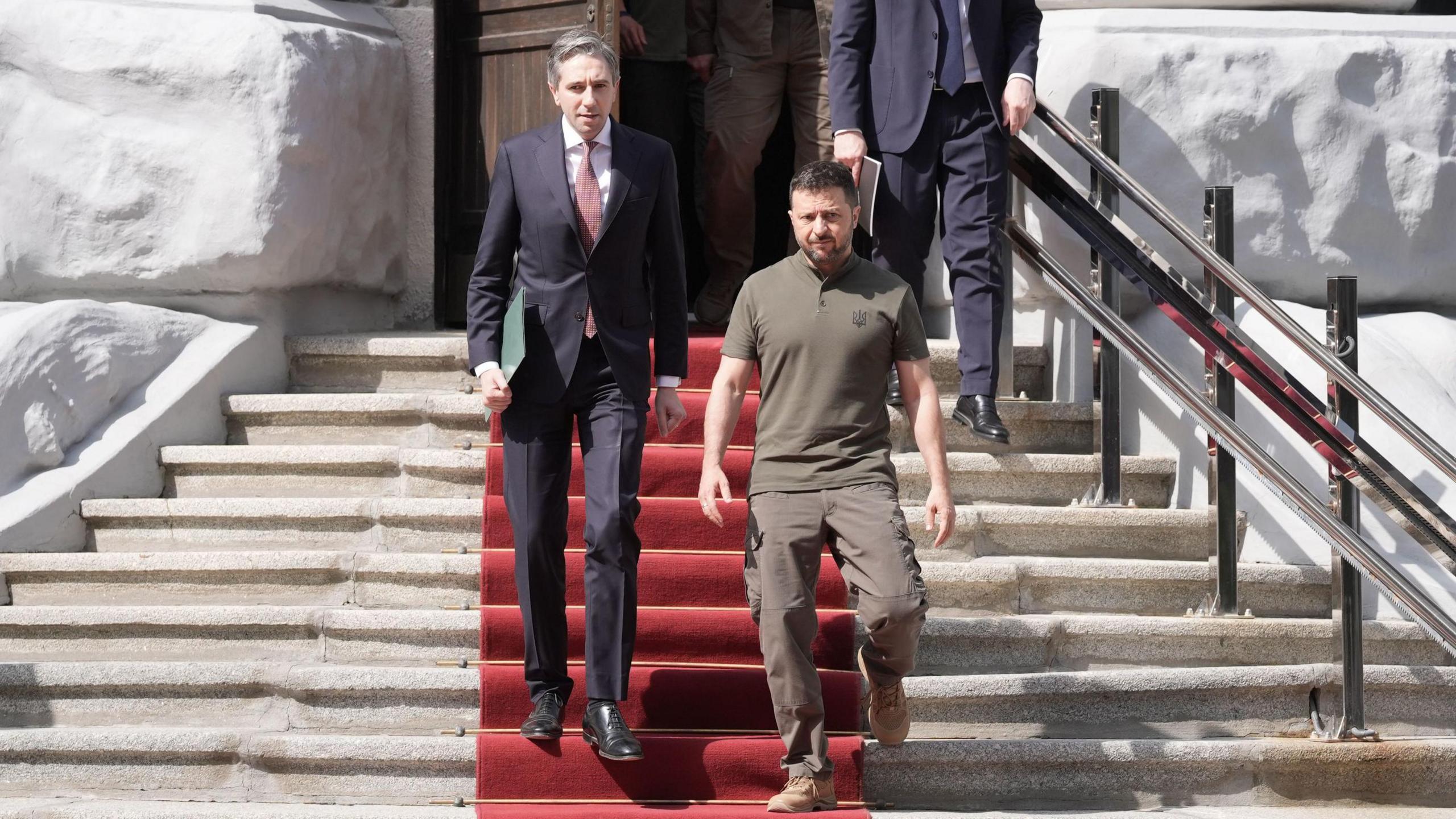 Simon Harris and Volodymyr Zelensky walked out of a building down some steps with a red carpet on them