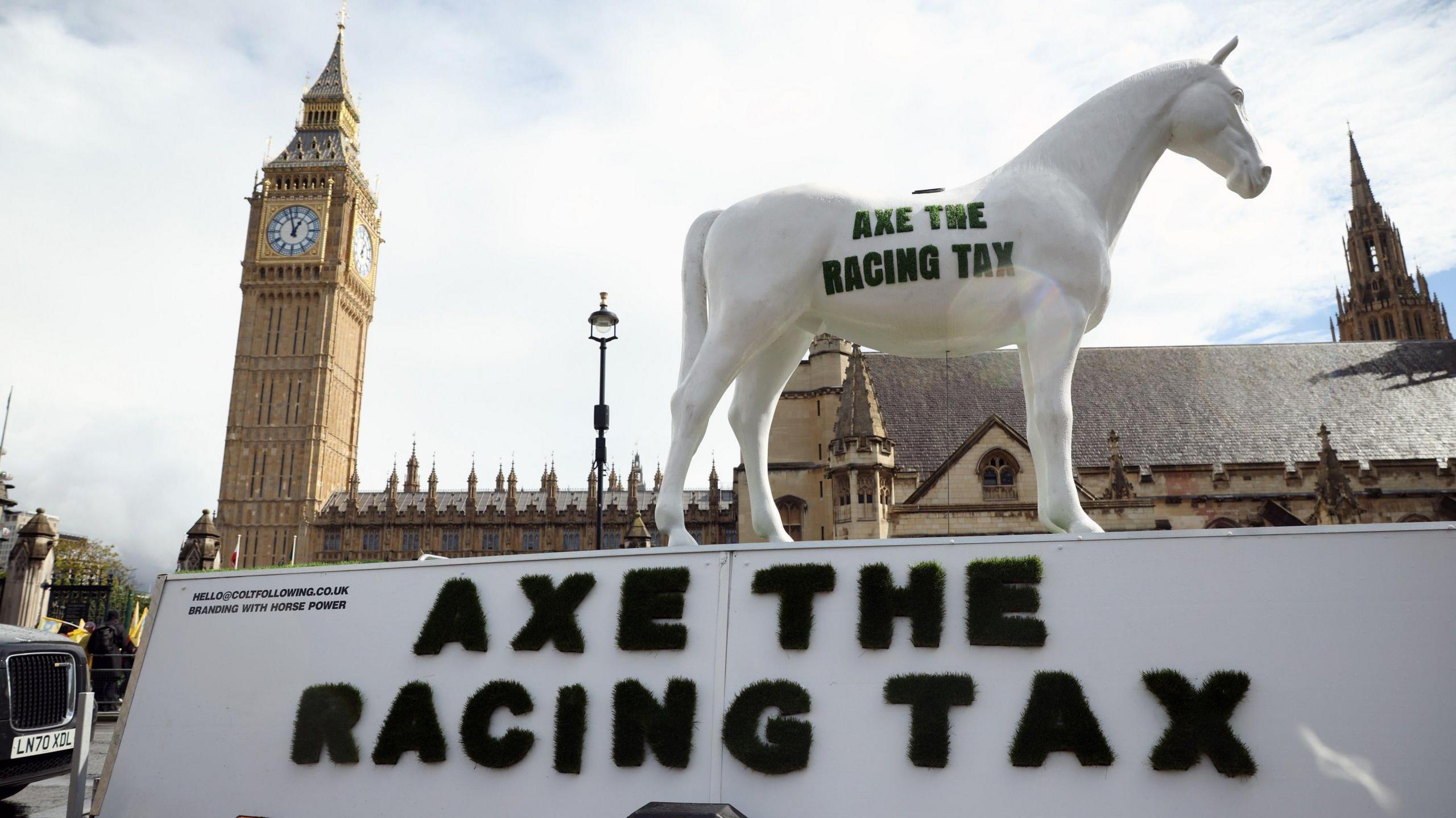 A statue of a horse with the 'Axe The Racing Tax' was part of a protest against the government's proposed tax rise on betting on horse racing