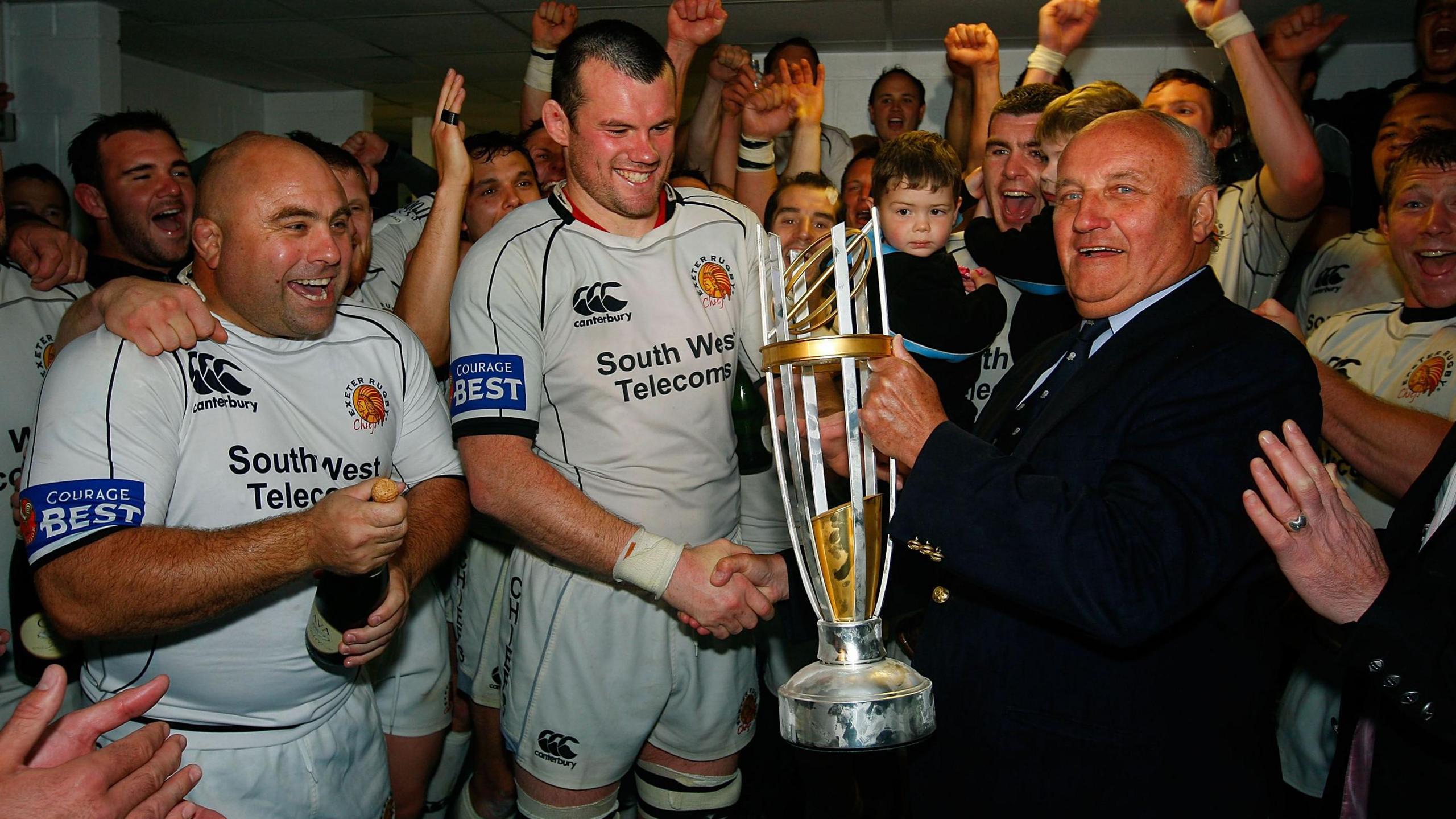 Exeter captain Tom Hayes is presented with the Championship trophy
