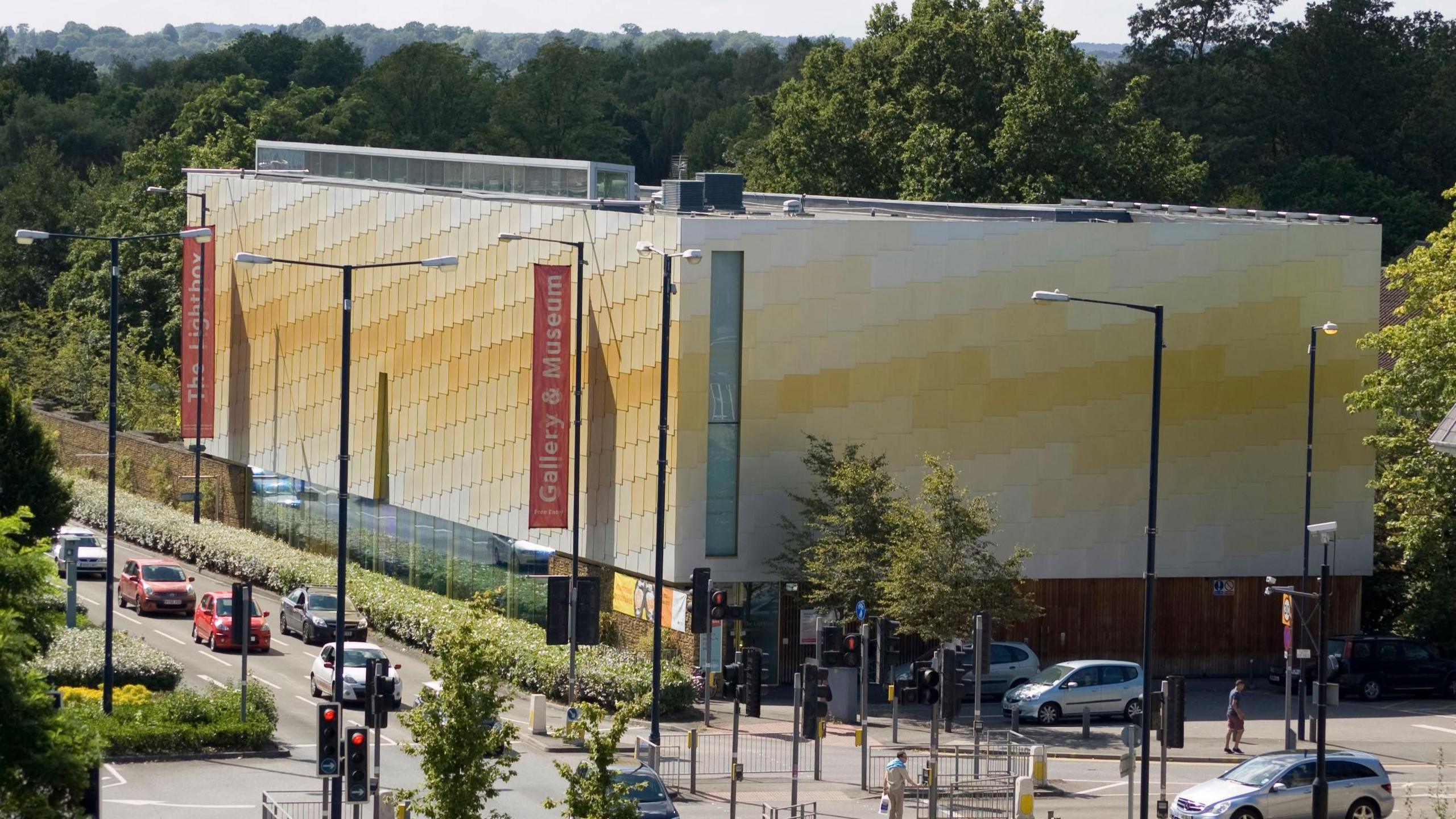 An aerial image of the Lightbox Gallery and Museum in Woking. There are also cars, traffic lights and pedestrians on Victoria Way.