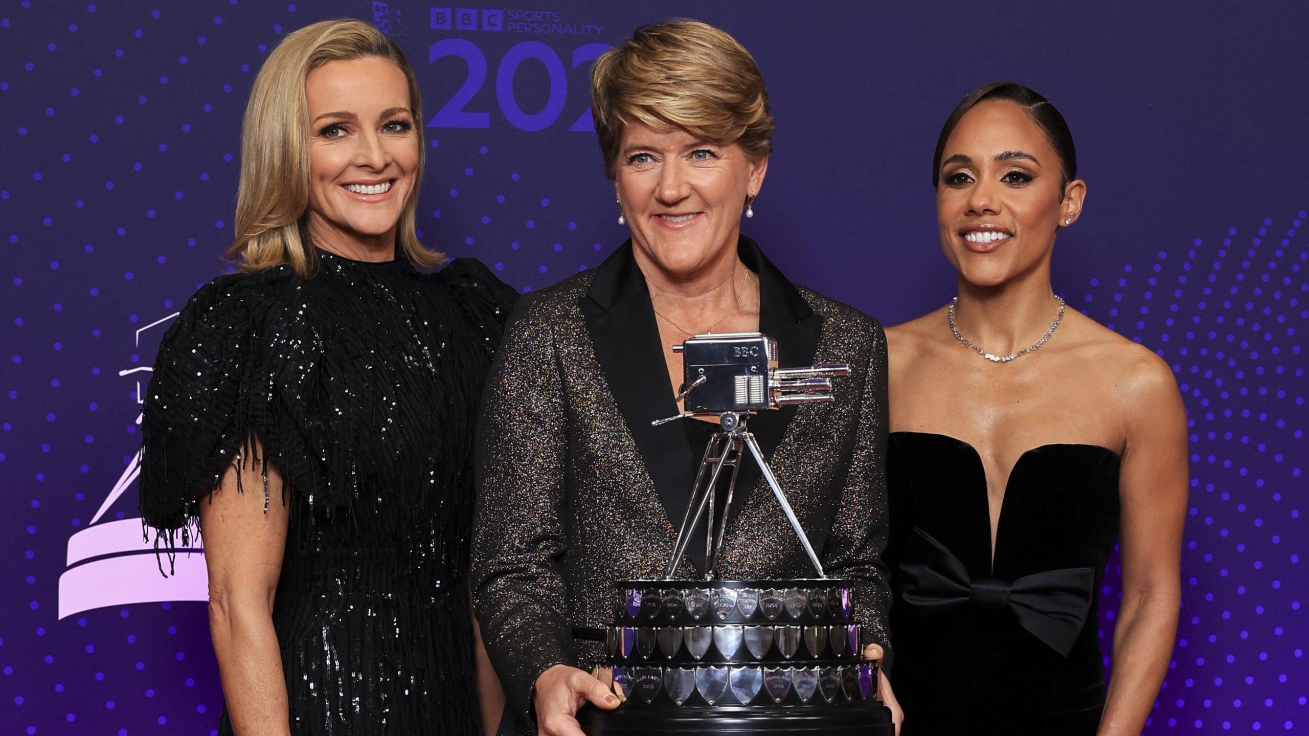 Gabby Logan (left), Clare Balding (centre) holding the SPOTY trophy and Alex Scott (right)