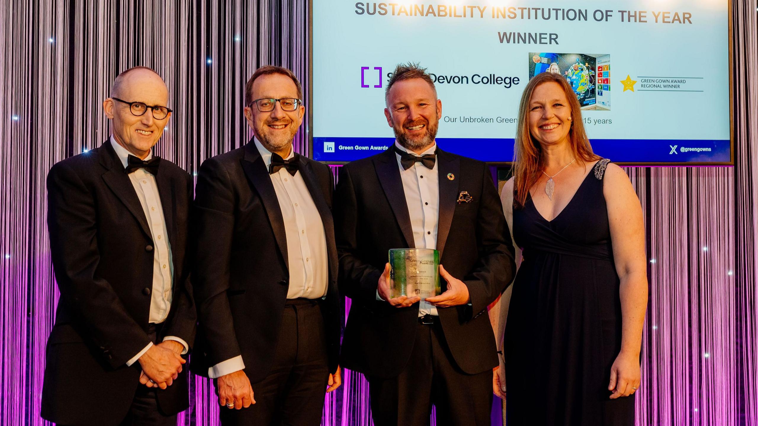 Dr Roddy Yarr, director of sustainability at University of Glasgow, Laurence Frewin, principal and CEO at South Devon College, Matt Green, head of commercial services and sustainability at South Devon College and Jo Allatt, head of sustainability. Dr Yarr, Mr Frewin and Mr Green are wearing black tuxedos while Ms Allatt is seen wearing a dark navy blue ball gown.