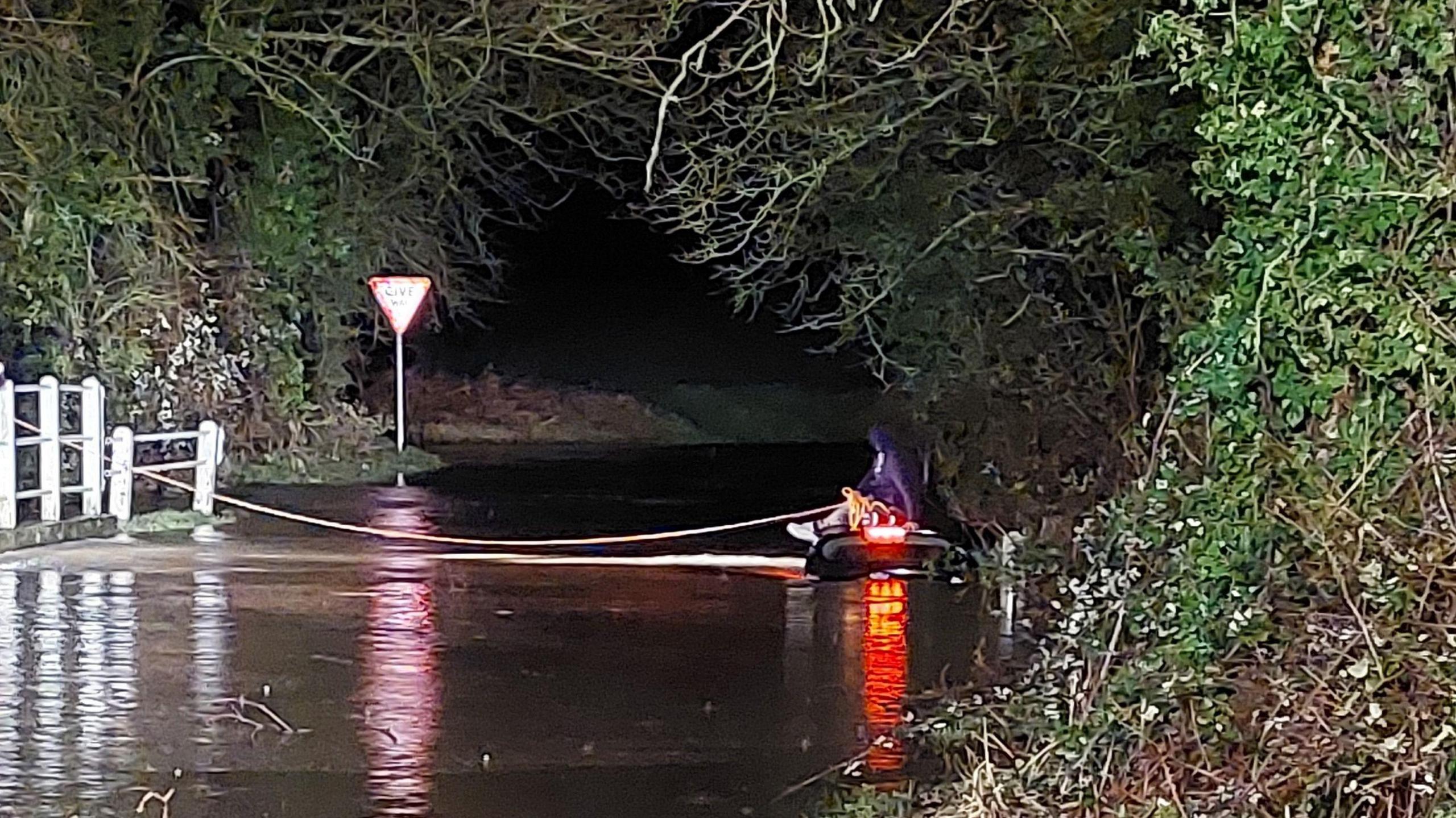 Driver on submerged car roof