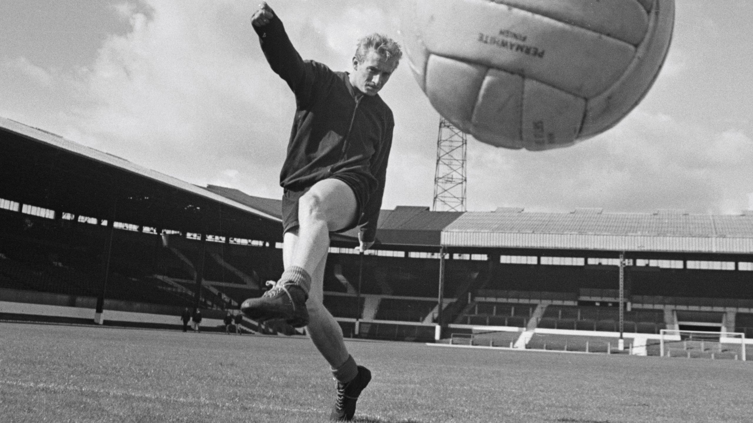 Denis Law kicking a ball