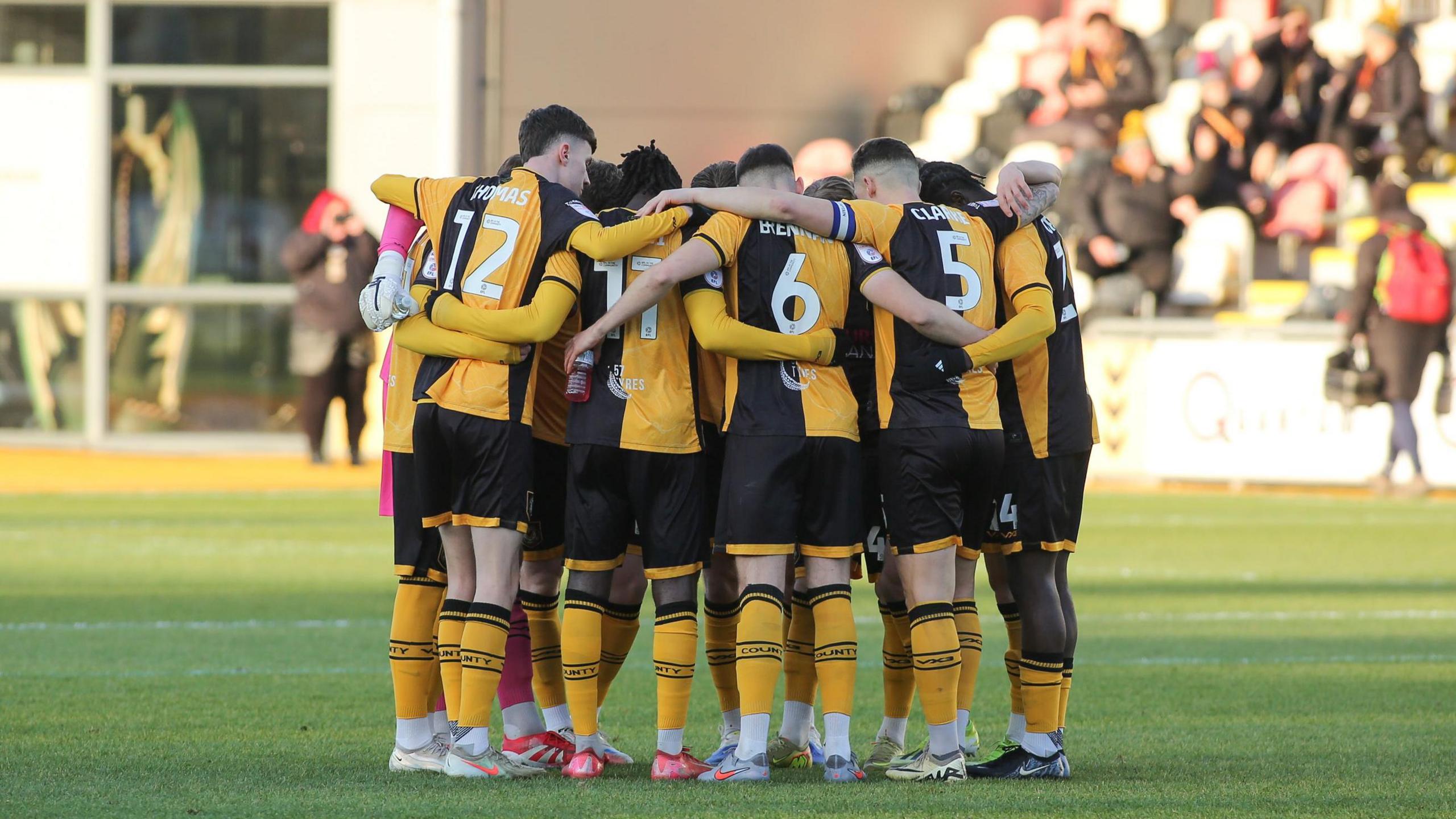 Newport County in a huddle at Rodney Parade