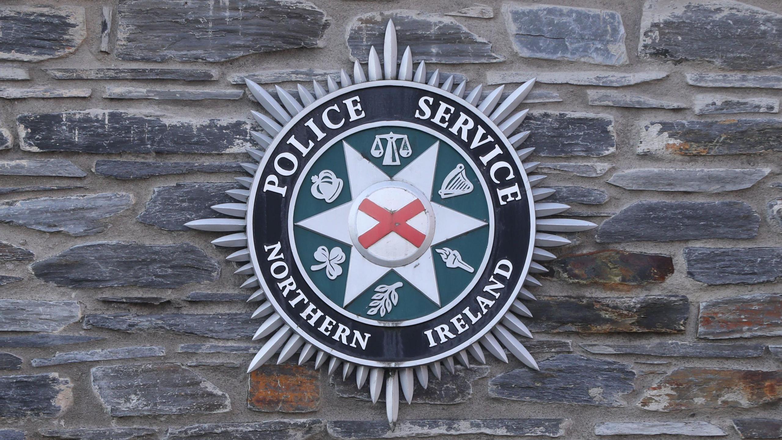 PSNI logo on a brick wall