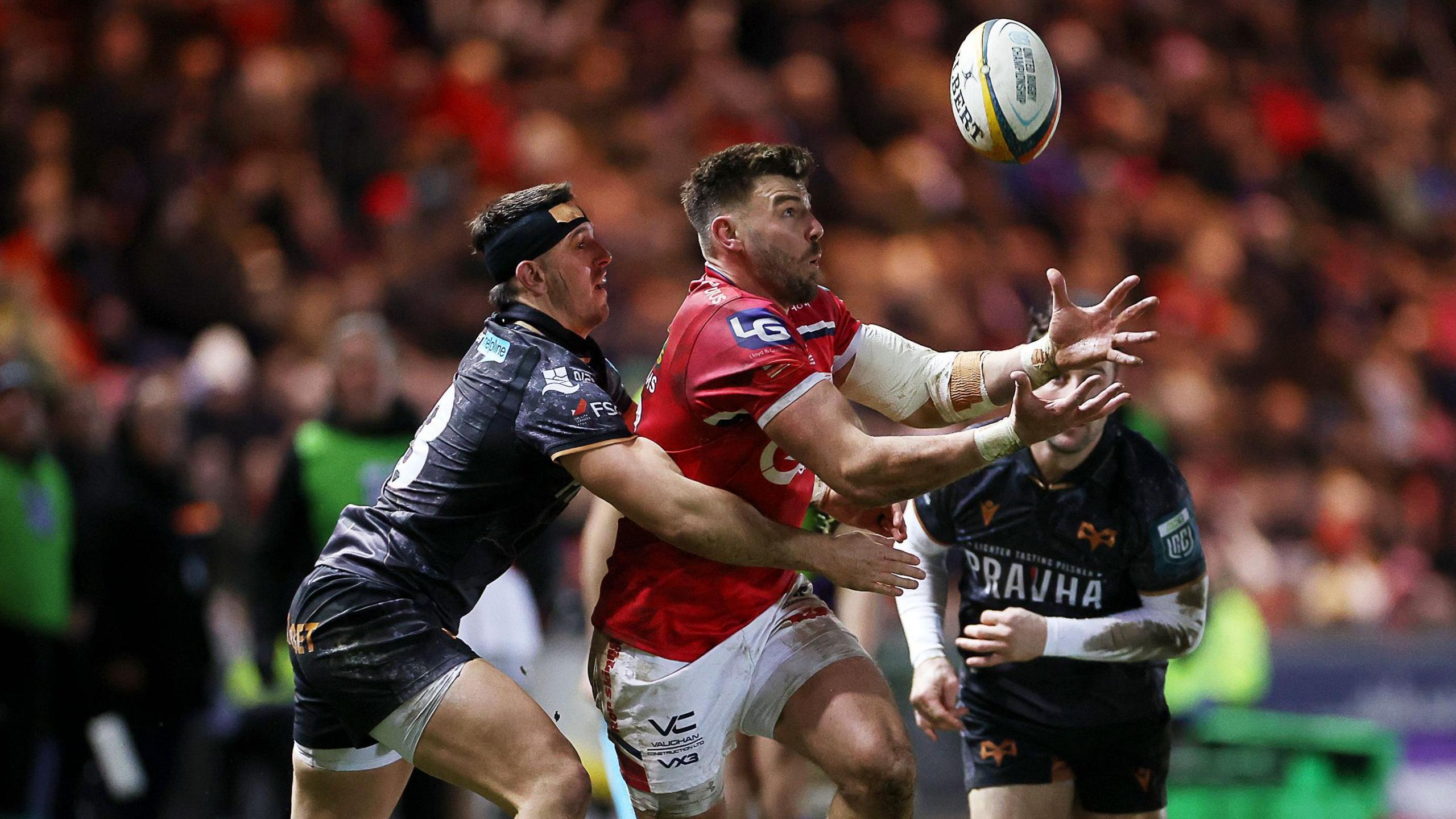 Owen Watkin tackles Johnny Williams in Ospreys' derby at Scarlets
