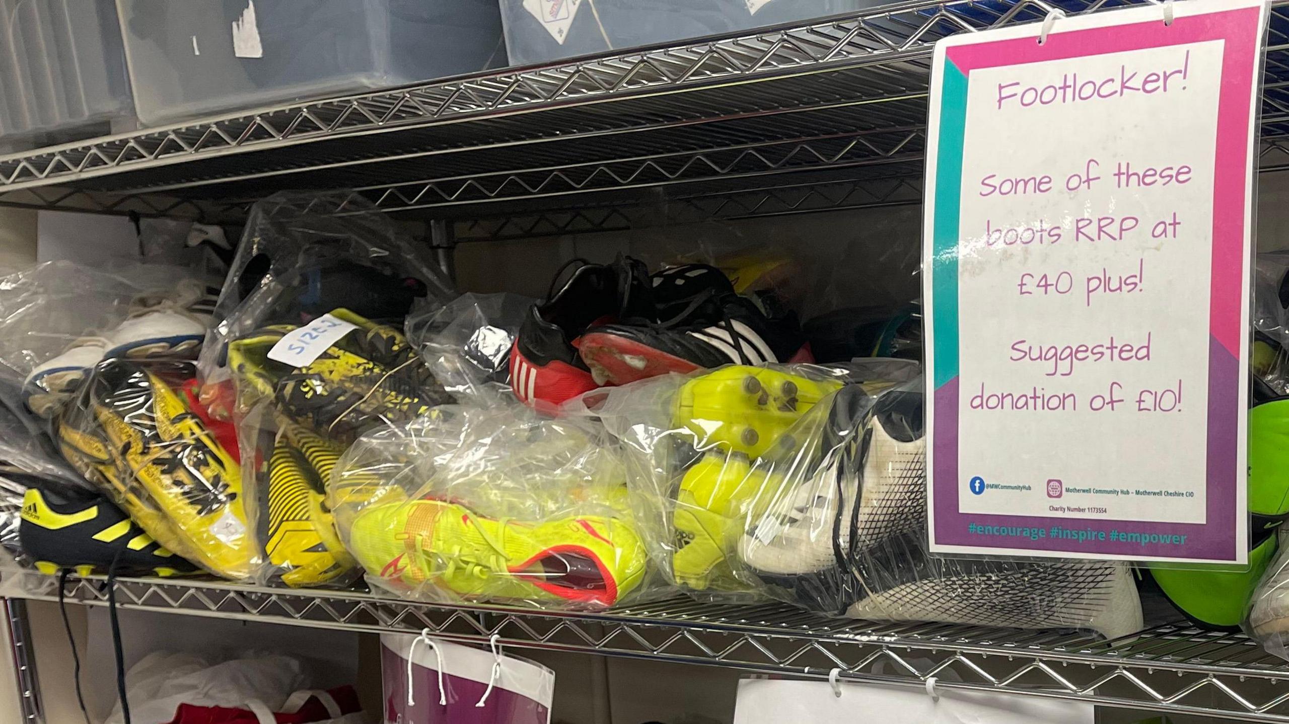 A pile of used football boots sit on a shelf in the charity’s hub