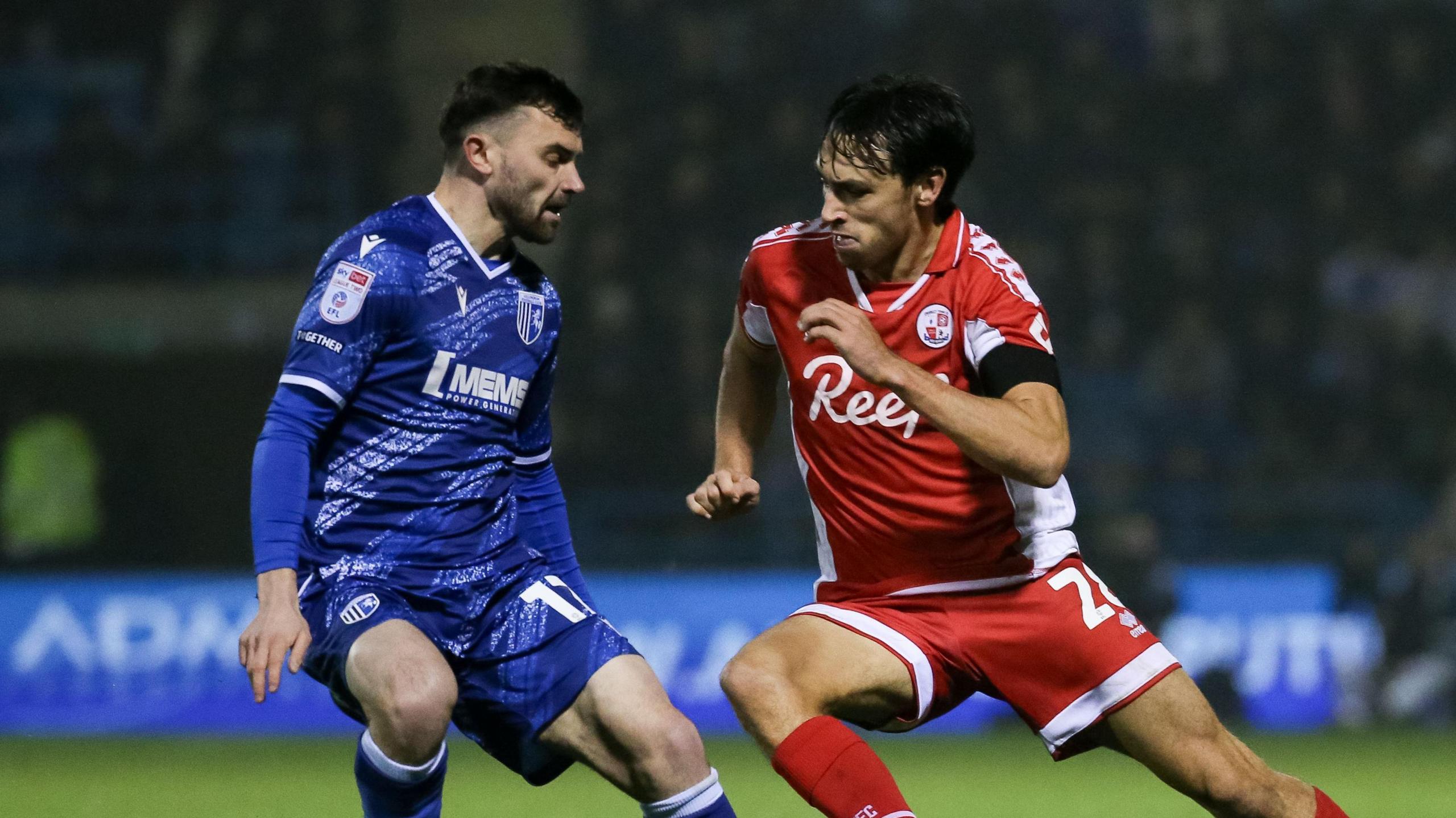 Gillingham's Jonny Smith in action with Crawley Town's Josh Flint.