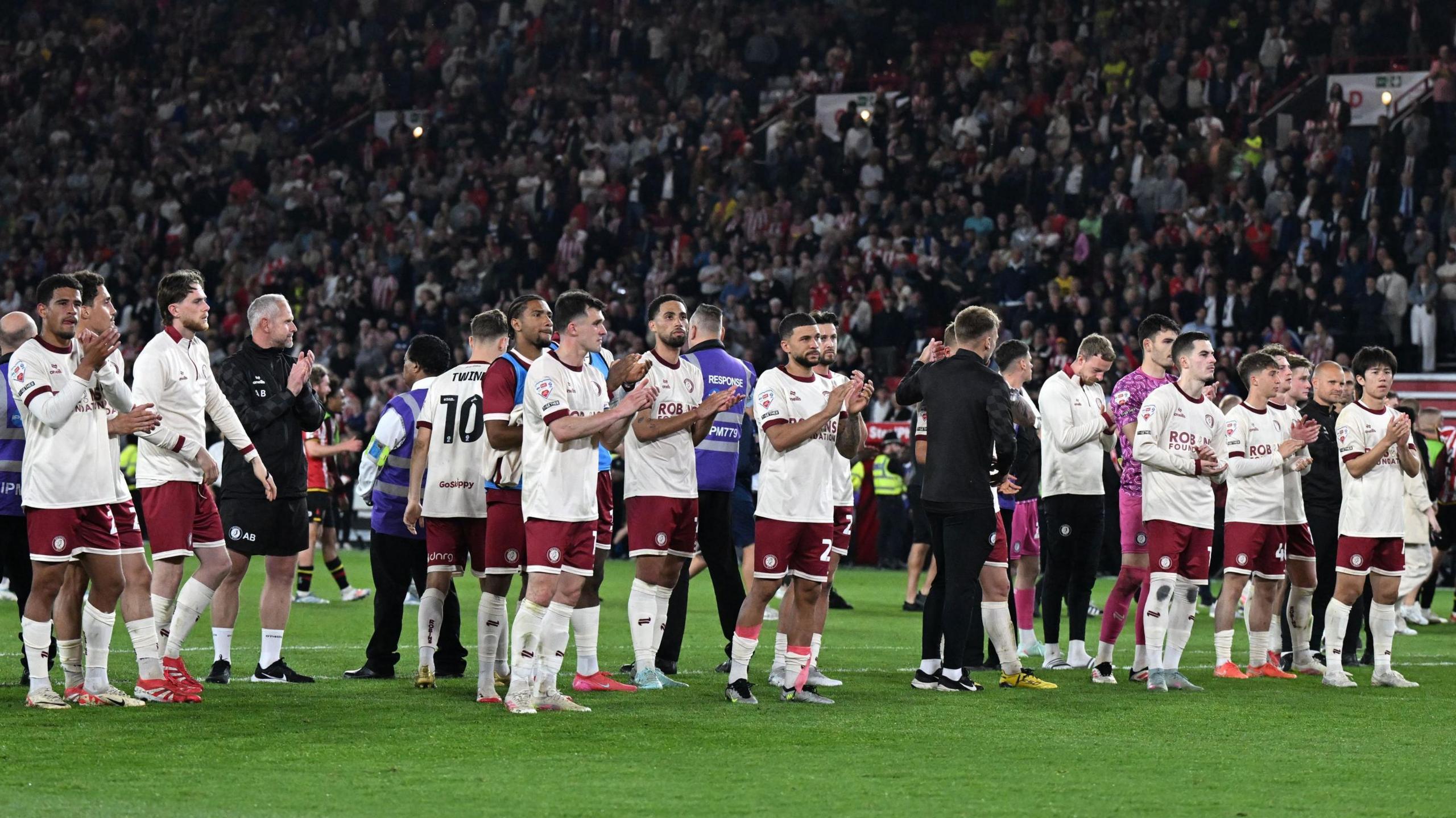 Bristol City players applaud their supporters