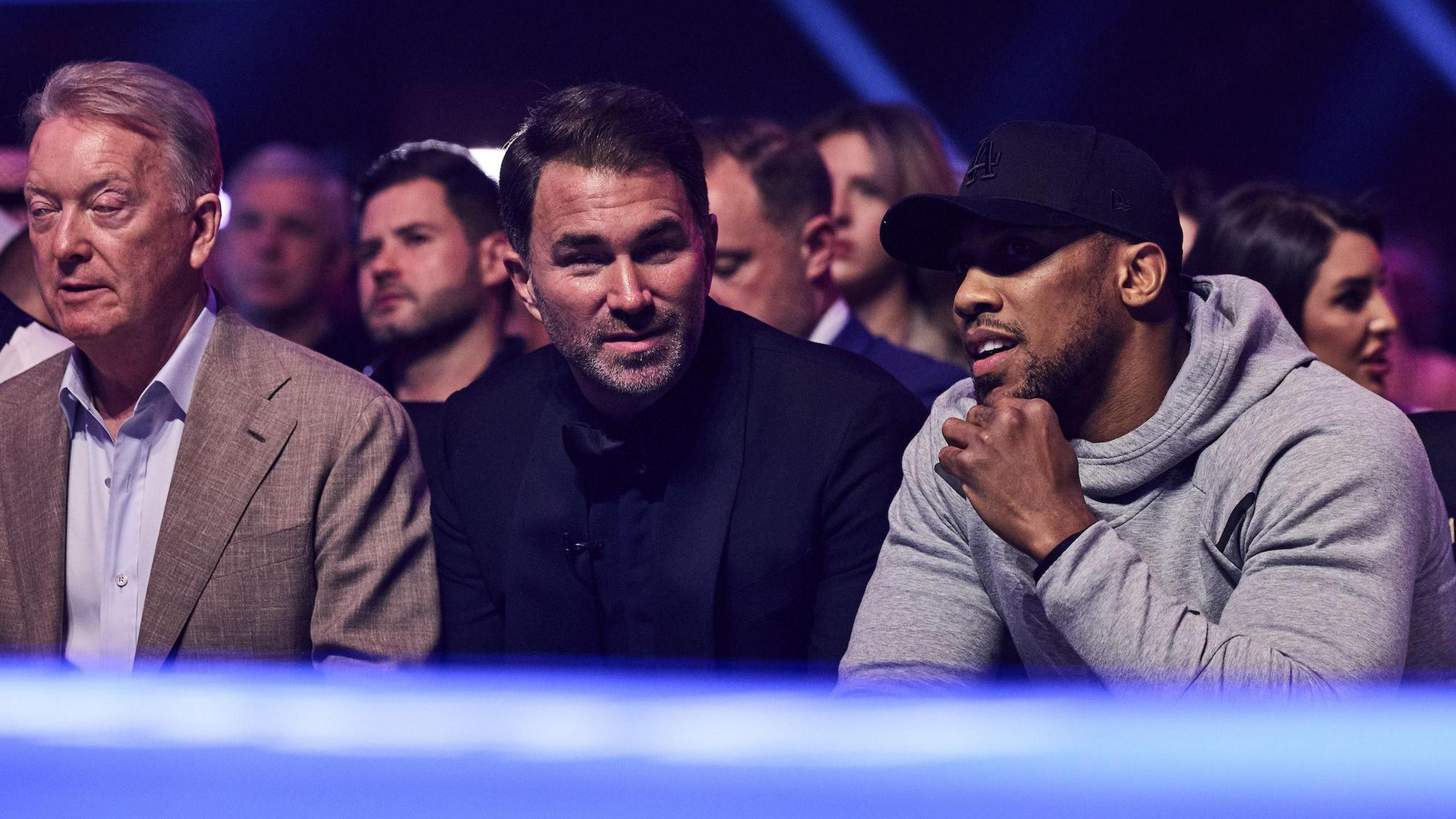 Frank Warren, Eddie Hearn and Anthony Joshua at ringside talking