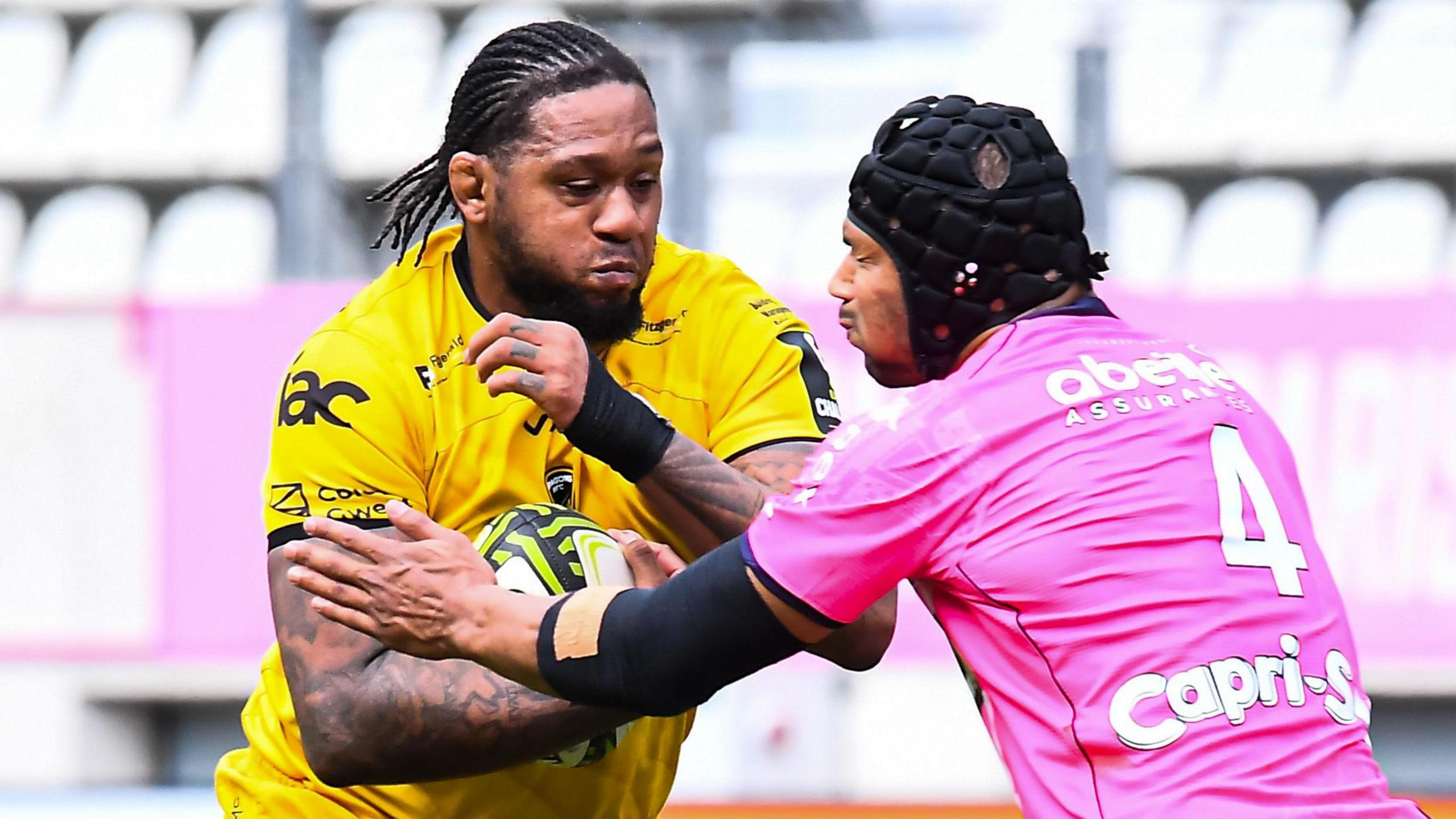 Lock Levi Douglas holds the ball under challenge from a Stade Francais forward