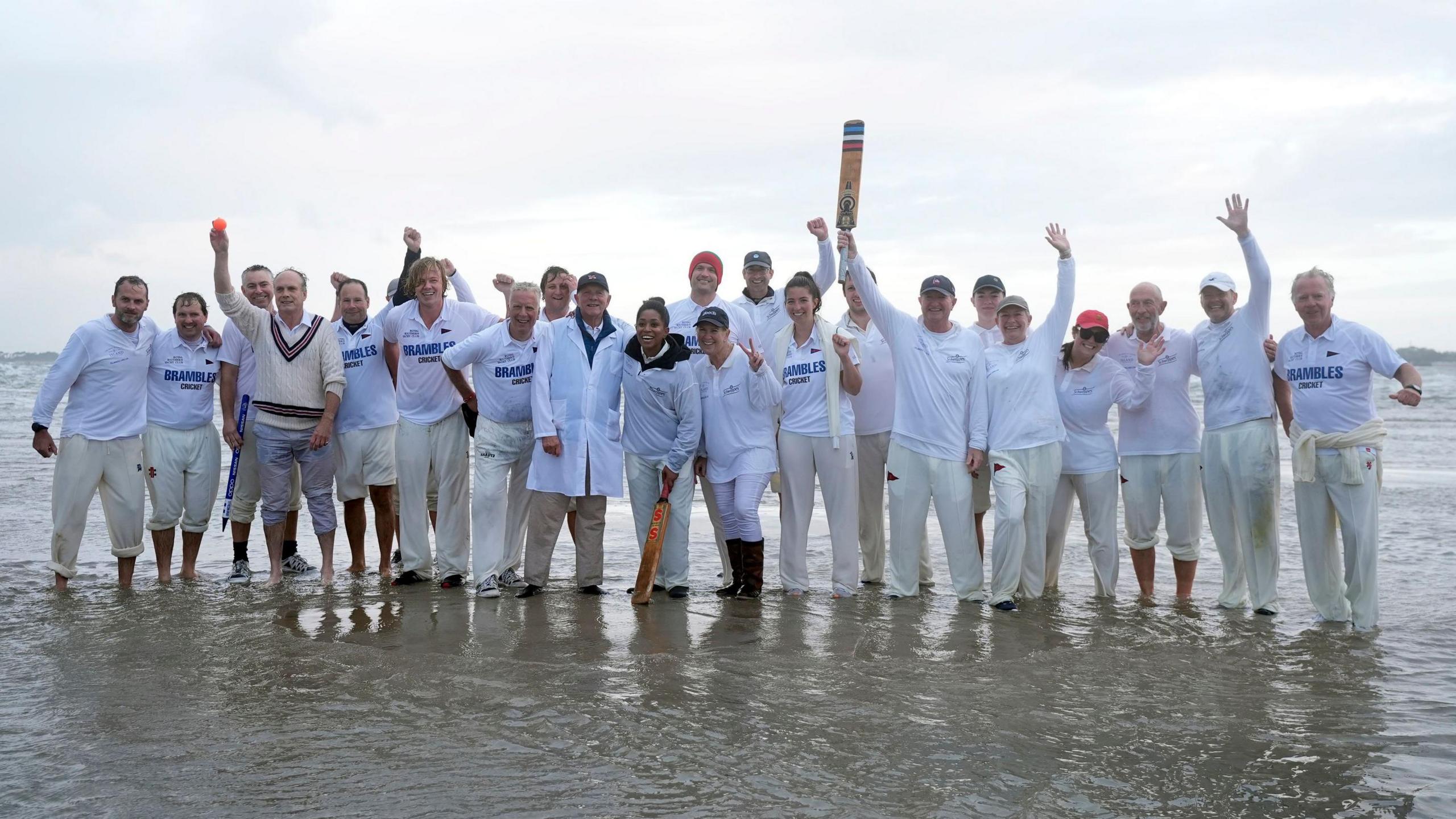 Members of the Royal Southern Yacht Club and the Island Sailing Club take part in the annual Brambles cricket match on the Bramble Bank sandbank in the middle of the Solent at low tide.