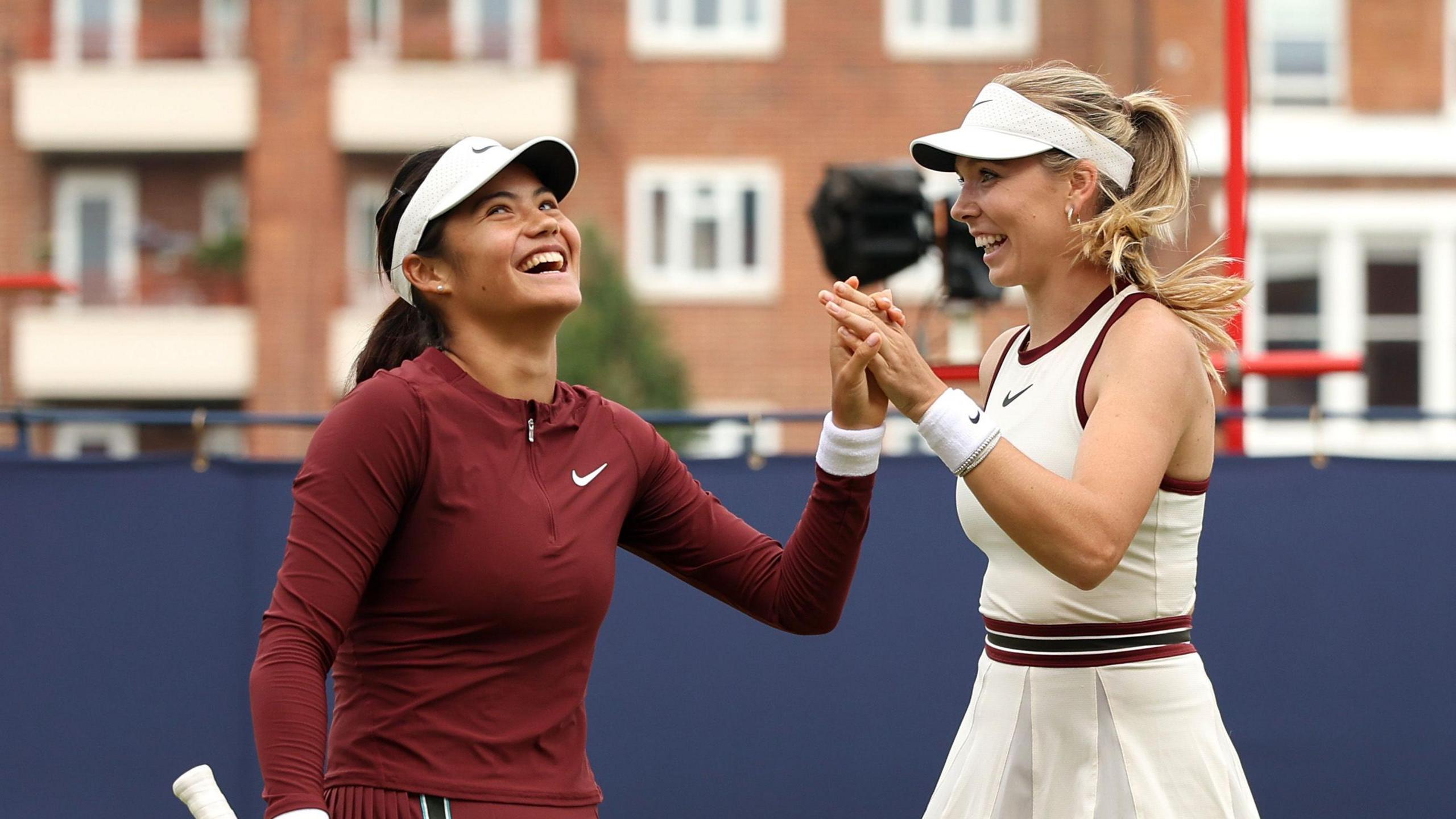 Emma Raducanu and Katie Boulter celebrate a point in their Queen's doubles match