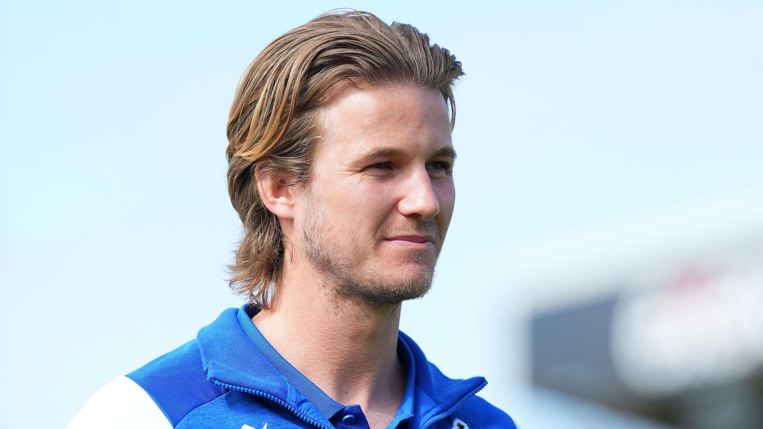 Tommy Leigh walking into the stadium before a match wearing Bristol Rovers clothing