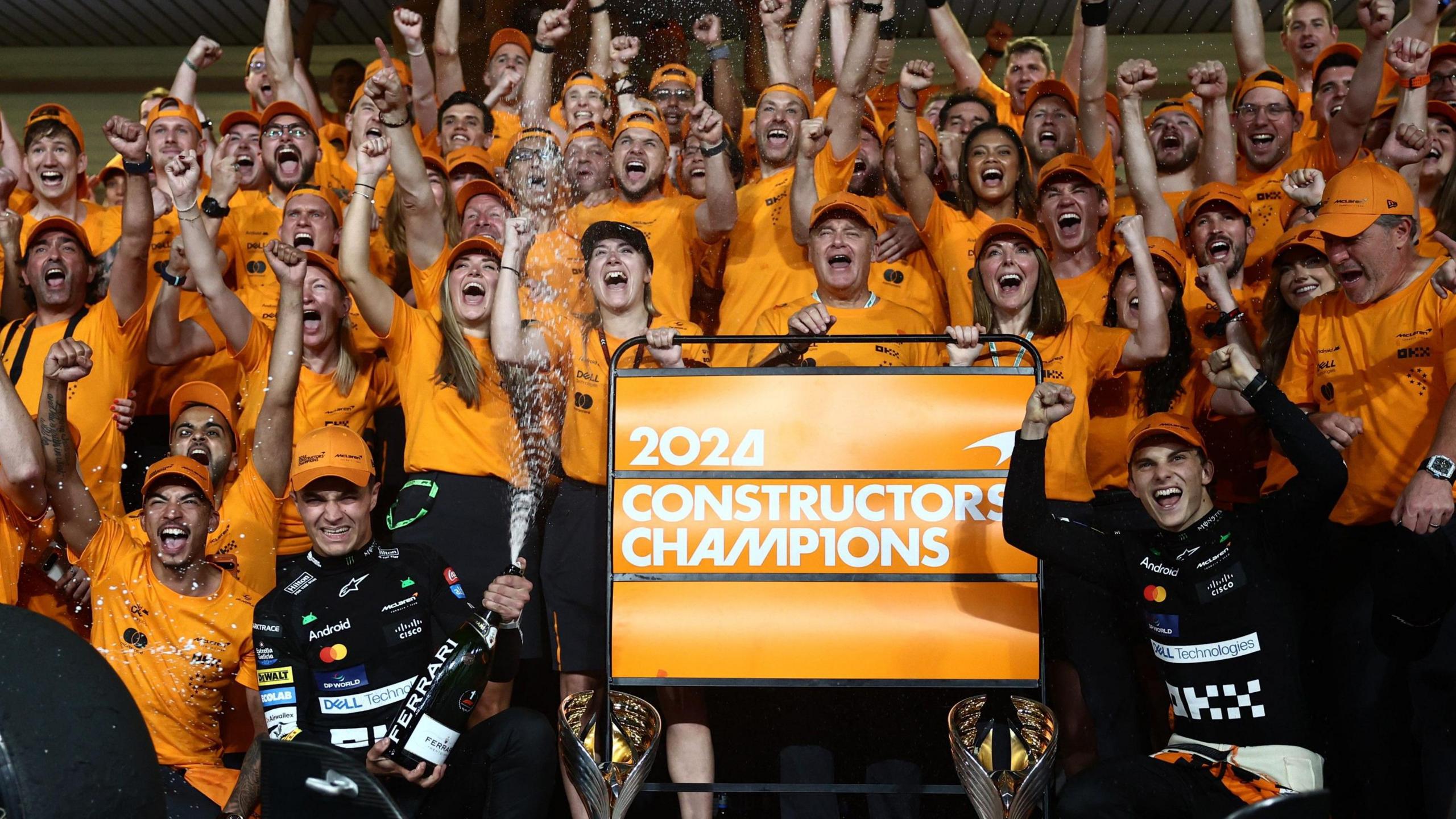 The McLaren team, including drivers Lando Norris and Oscar Piastri, celebrate winning the 2024 constructors' championship in Abu Dhabi