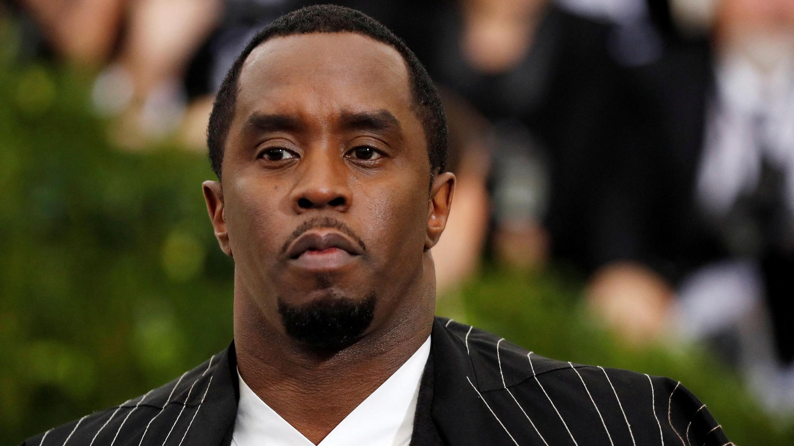 Sean "Diddy" Combs in a pinstripe suit at the Met Gala, before his arrest on sex trafficking charges