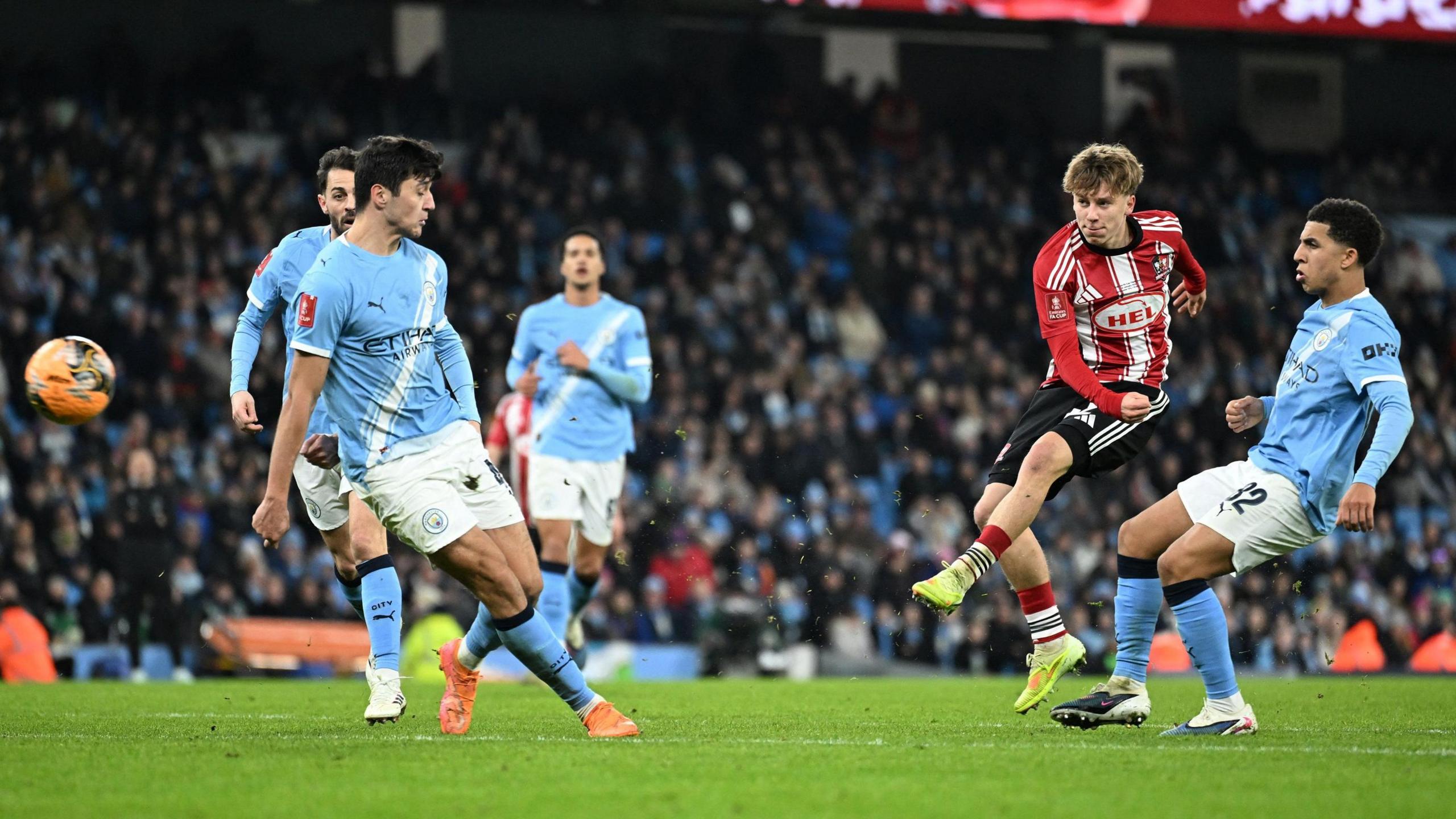 George Birch strikes his goal-bound shot at Manchester City