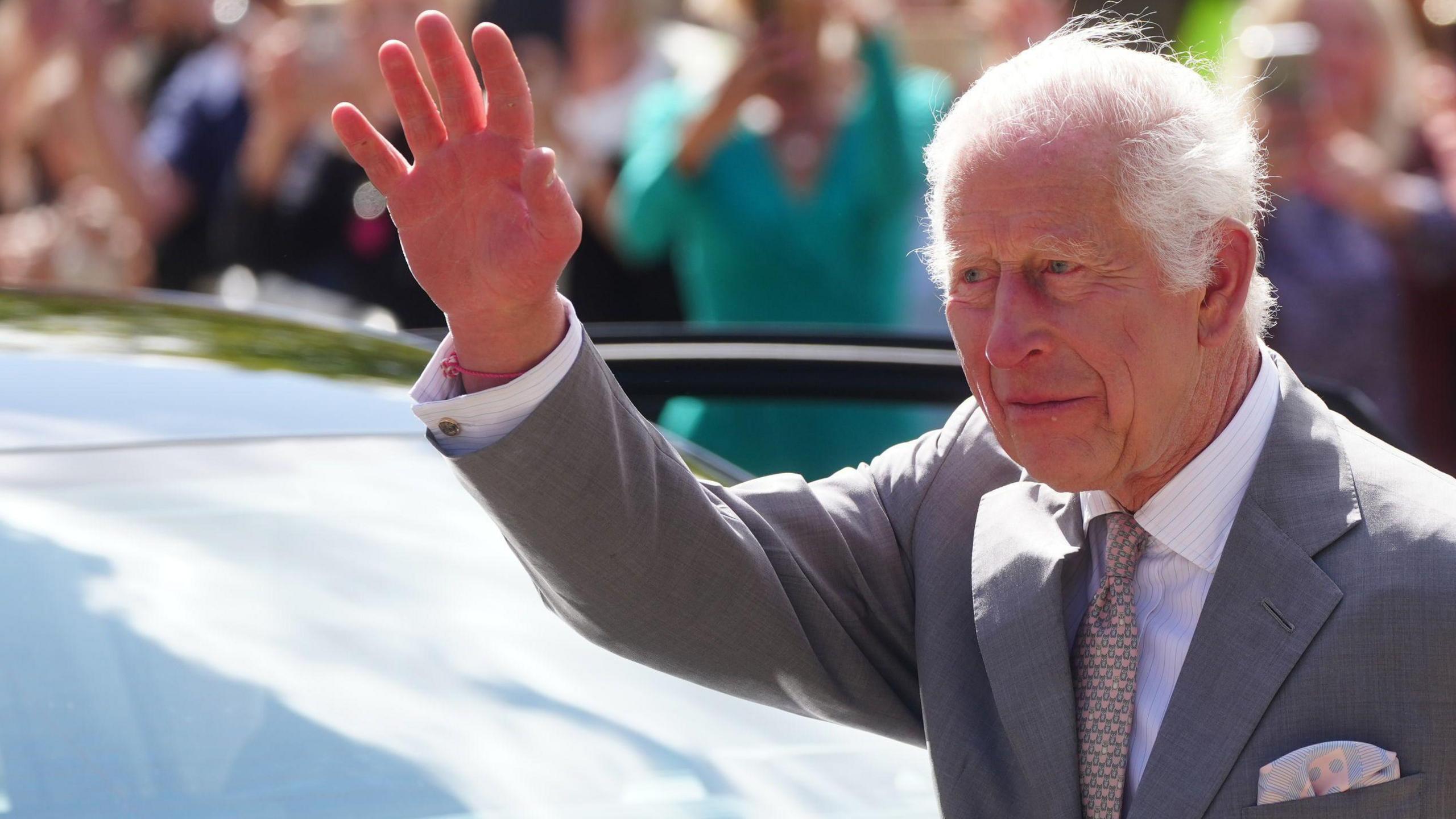 King Charles waves as he leaves Southport Town Hall after he met with members of the Southport community