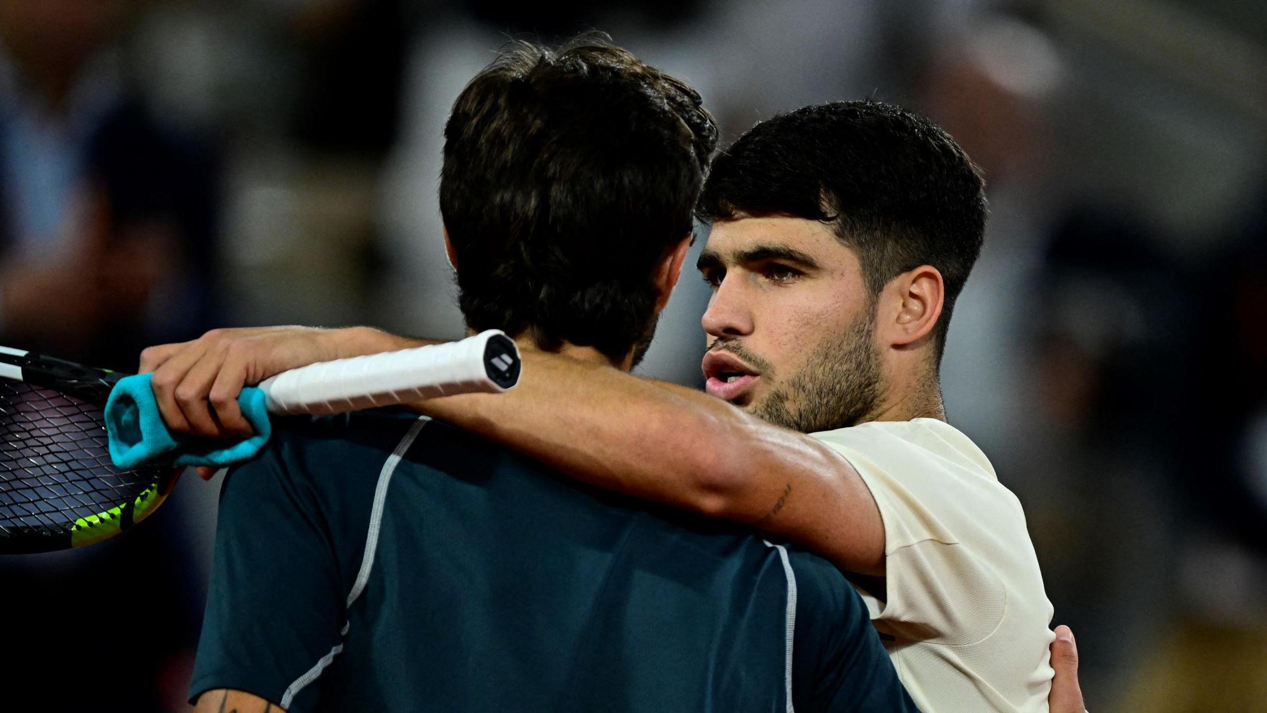 Carlos Alcaraz hugs Lorenzo Musetti