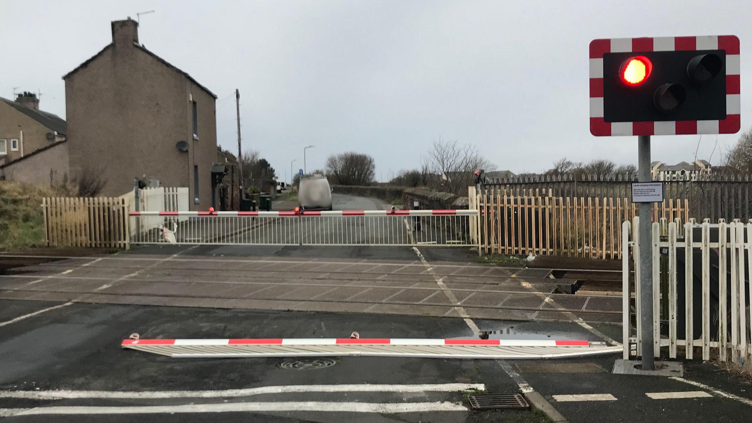 A barrier on the ground at the level crossing at Grasslot.