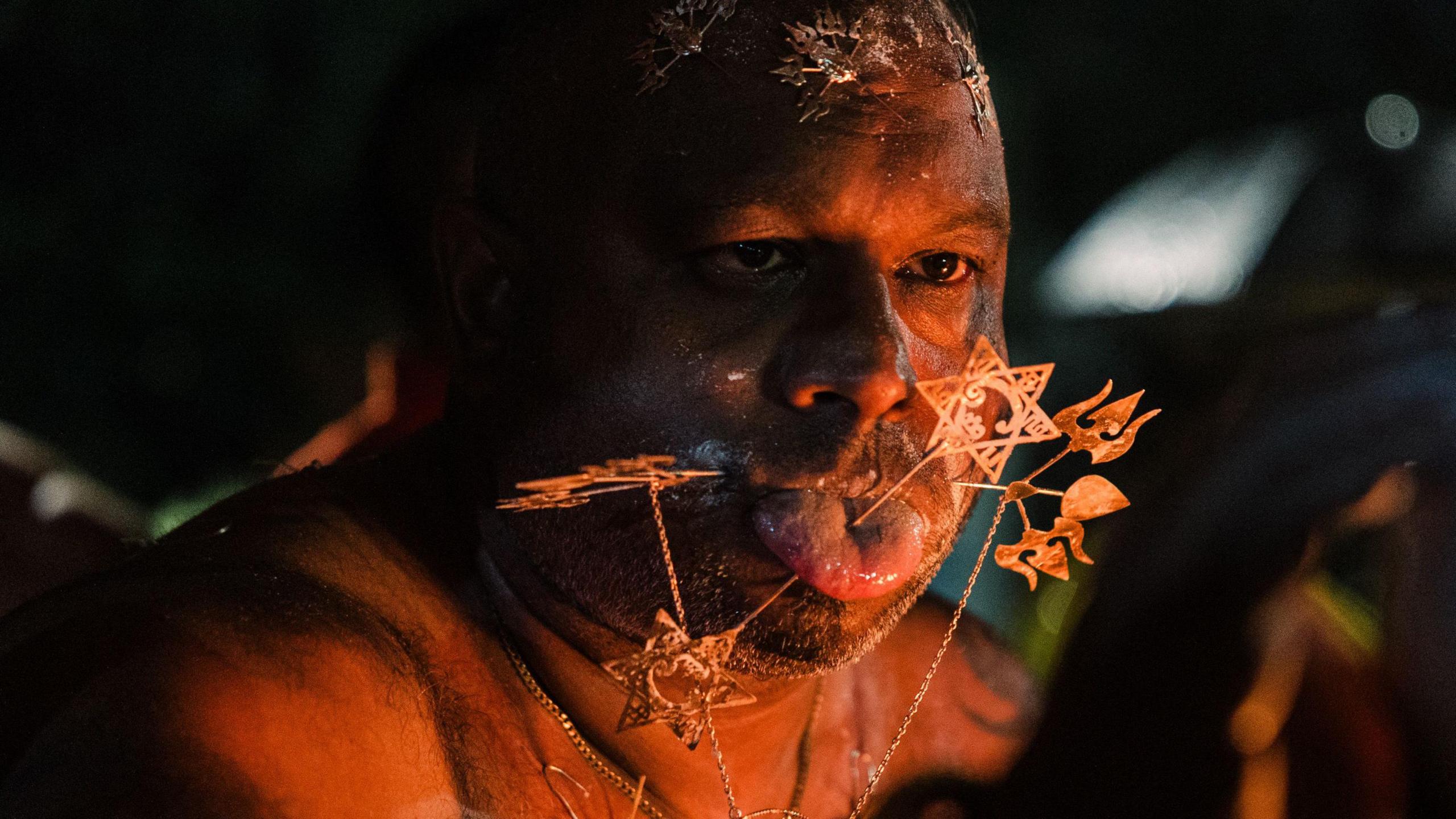 A man with piercings gives blessings during the  annual Hindi festival Thaipoosam Kavady in a township in Durban, South Africa - Monday 10 February 2025