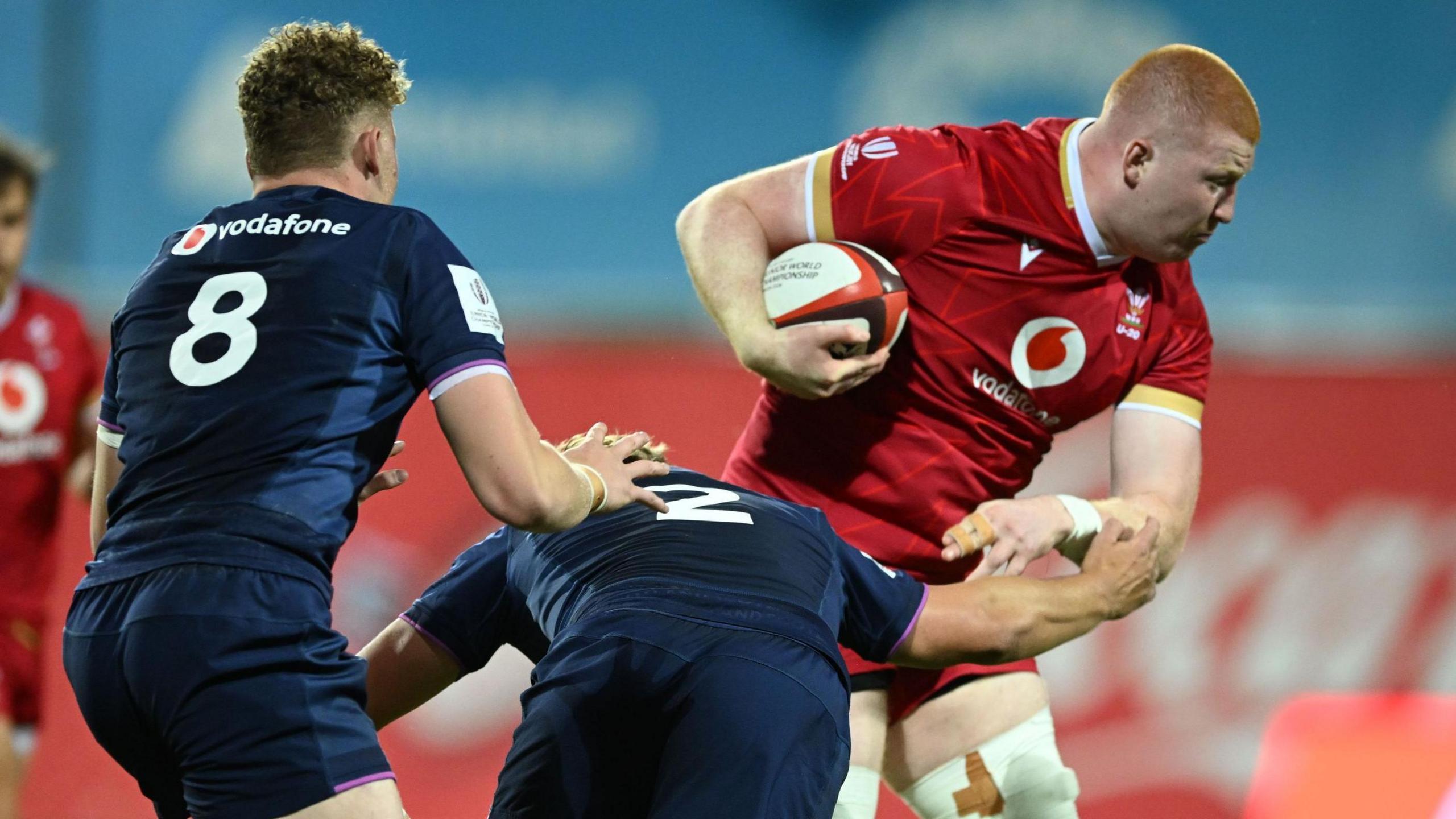 Will Evans carries the ball under his right arm for Wales Under-20s against Scotland