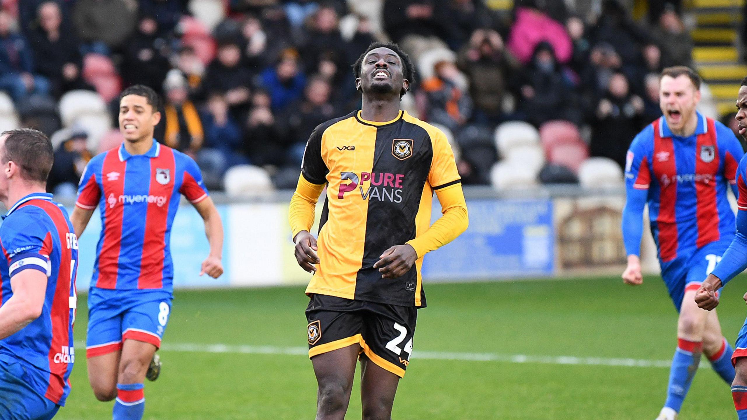 Nathaniel Opoku surrounded by Grimsby players after he missed a penalty for Newport County