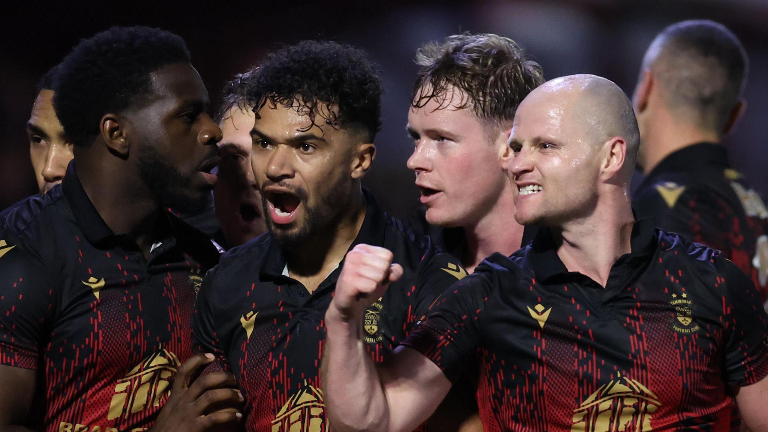 Tamworth Town players celebrate their first-half goal against Huddersfield Town in the FA Cup first-round