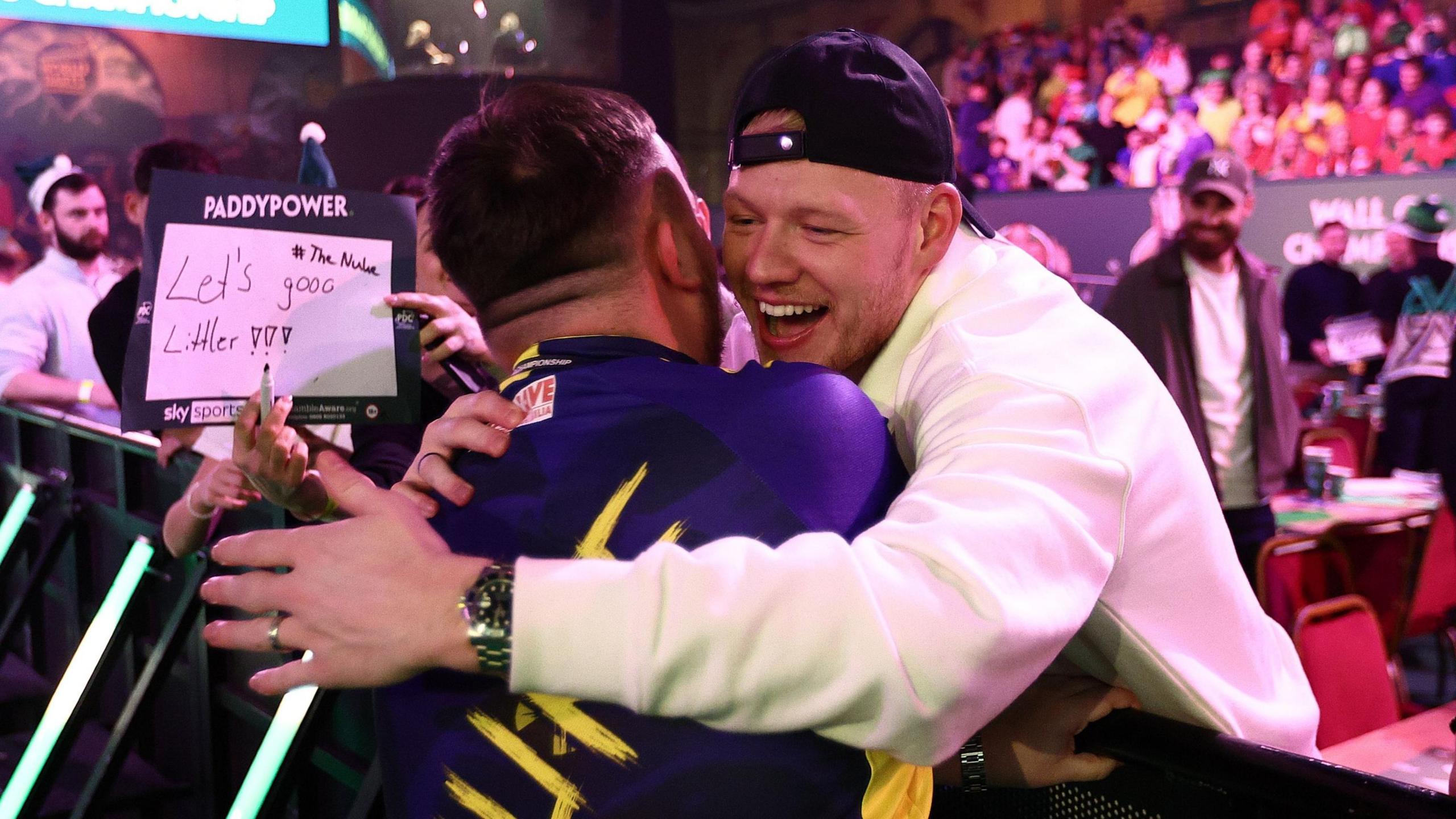 Luke Littler celebrates his win with Southampton and England goalkeeper Aaron Ramsdale