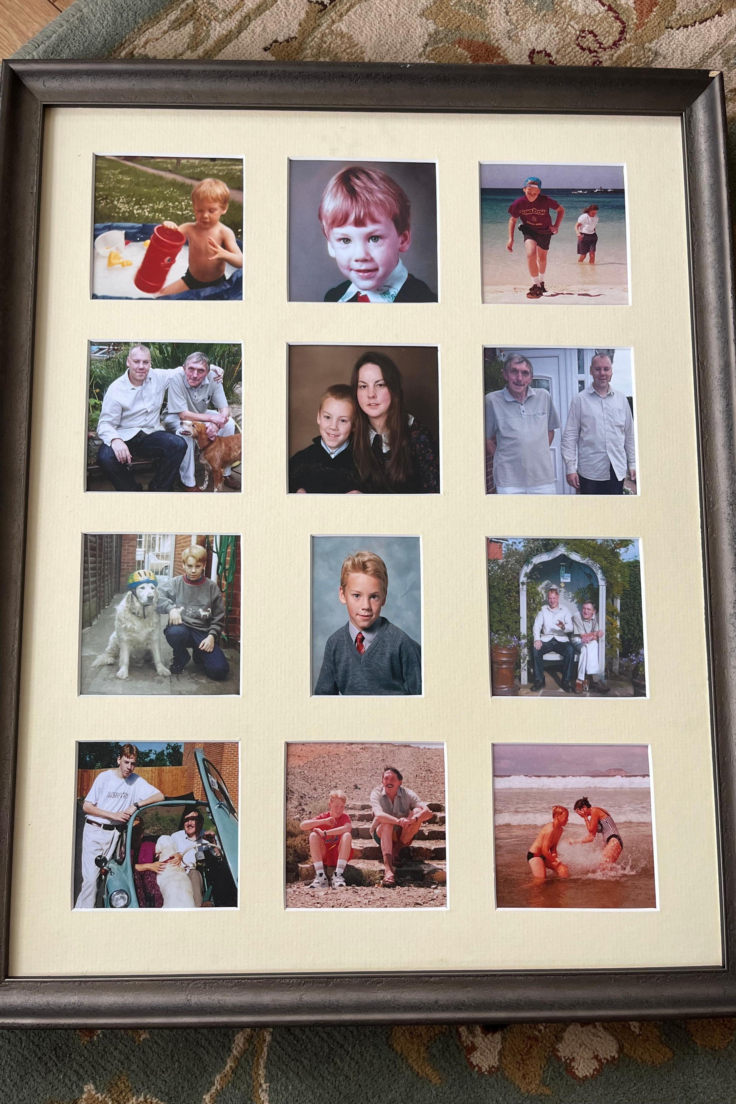 A black photo frame with 12 small boxes in it, all with different pictures of a boy in it. Some are of him as a young child, others as a teenager, and some as an adult. The frame is laid out on a carpet.