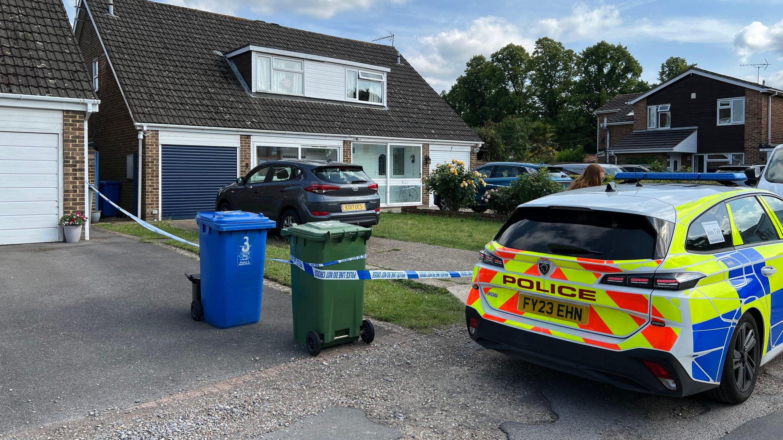 A police car and police tape outside a detached house in Maidenhead.