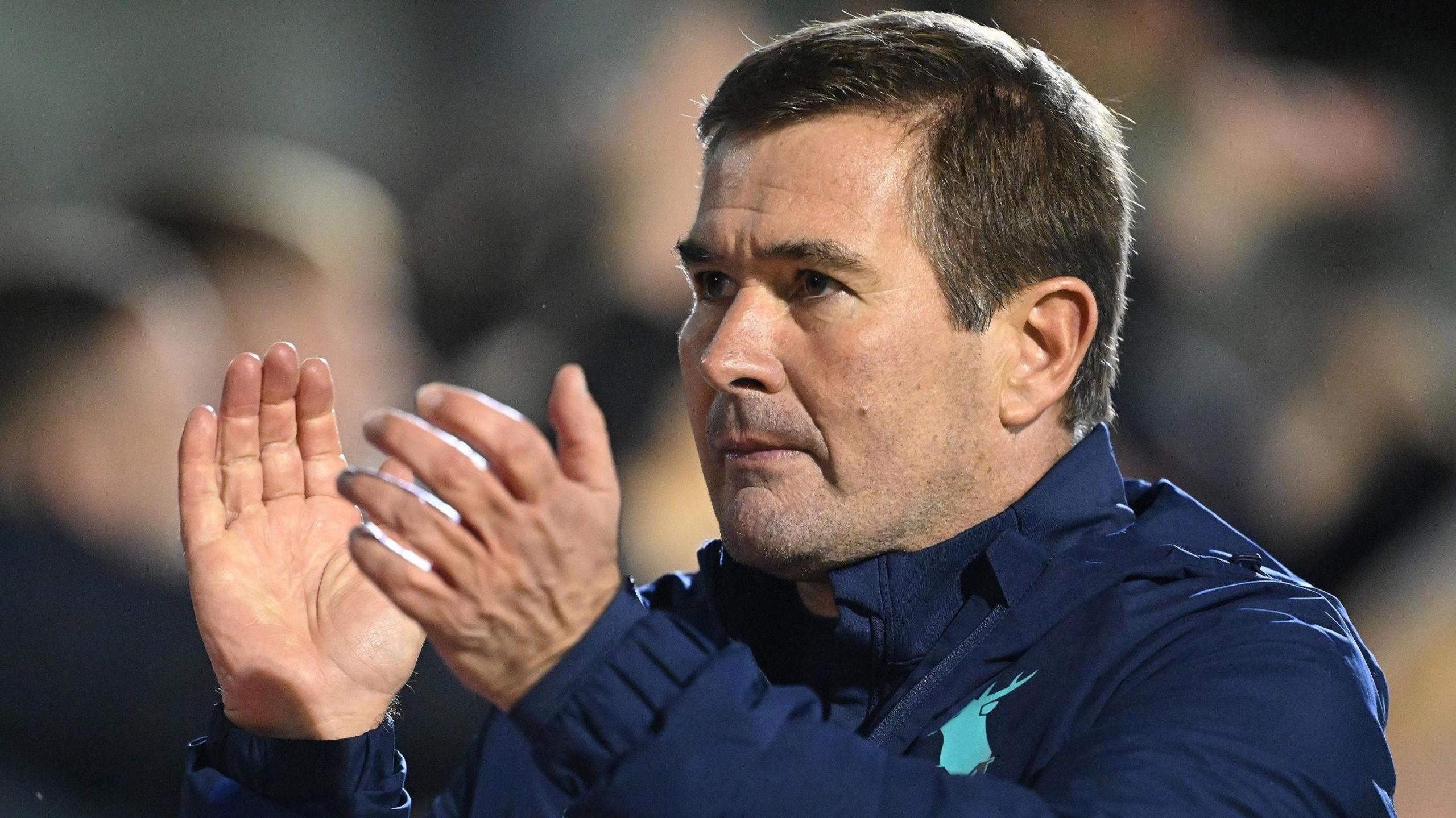 Mansfield Town boss Nigel Clough claps after the game.