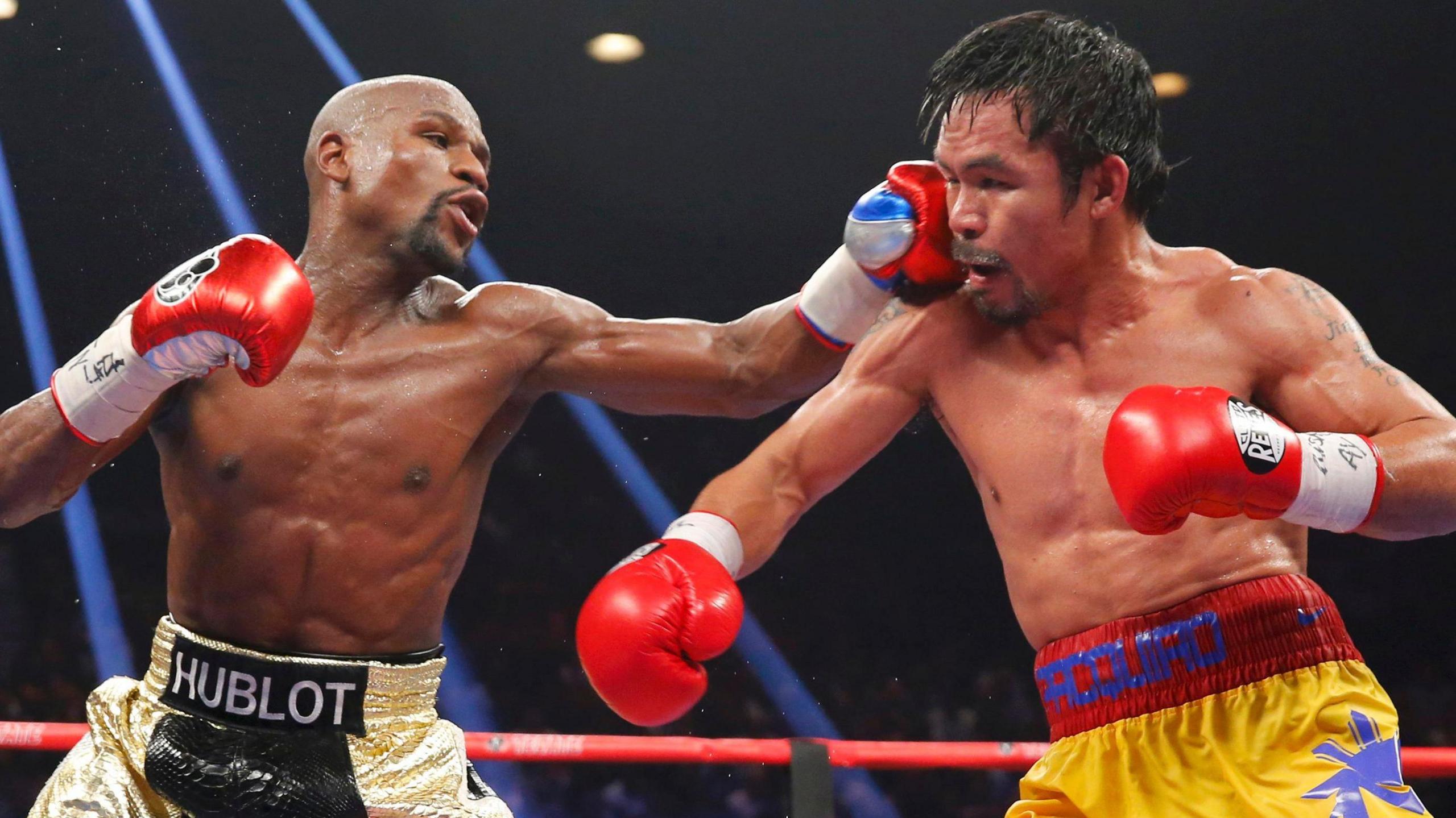 Floyd Mayweather punches Manny Pacquiao during their fight in 2015