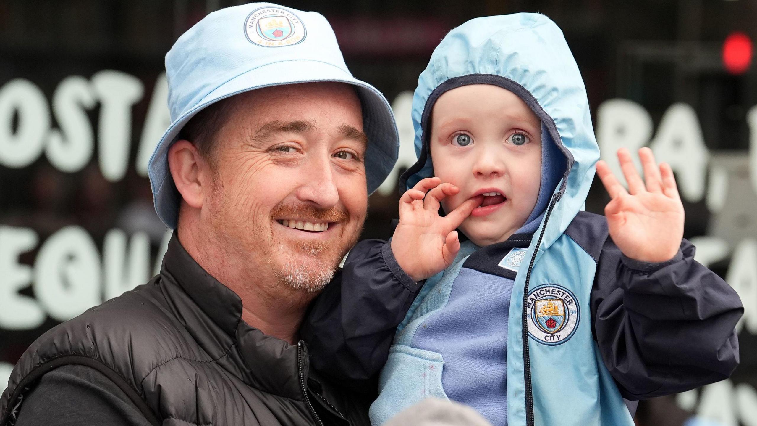 A man and his son celebrate Manchester City's title win